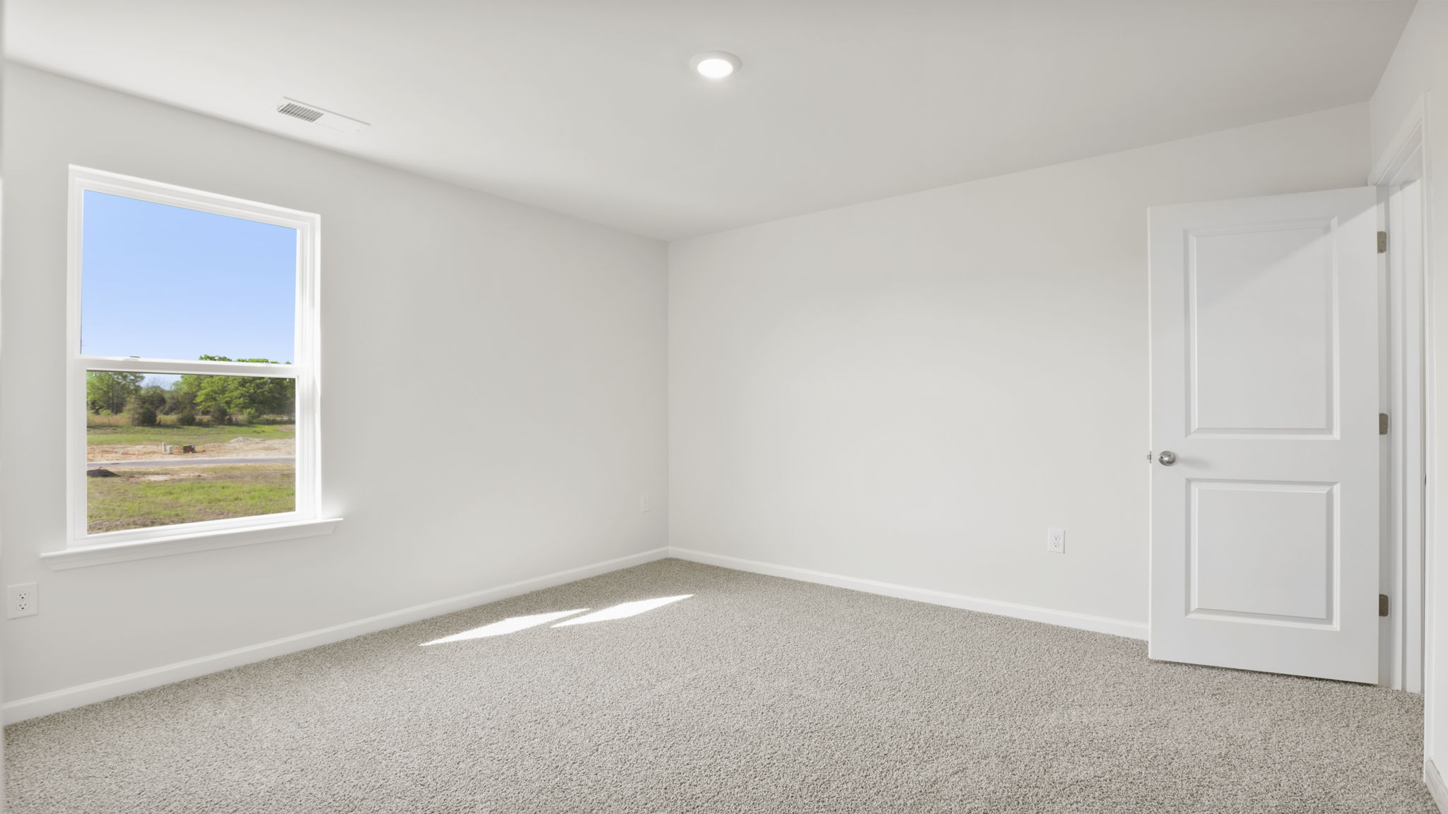 Bedroom with carpet and windows.