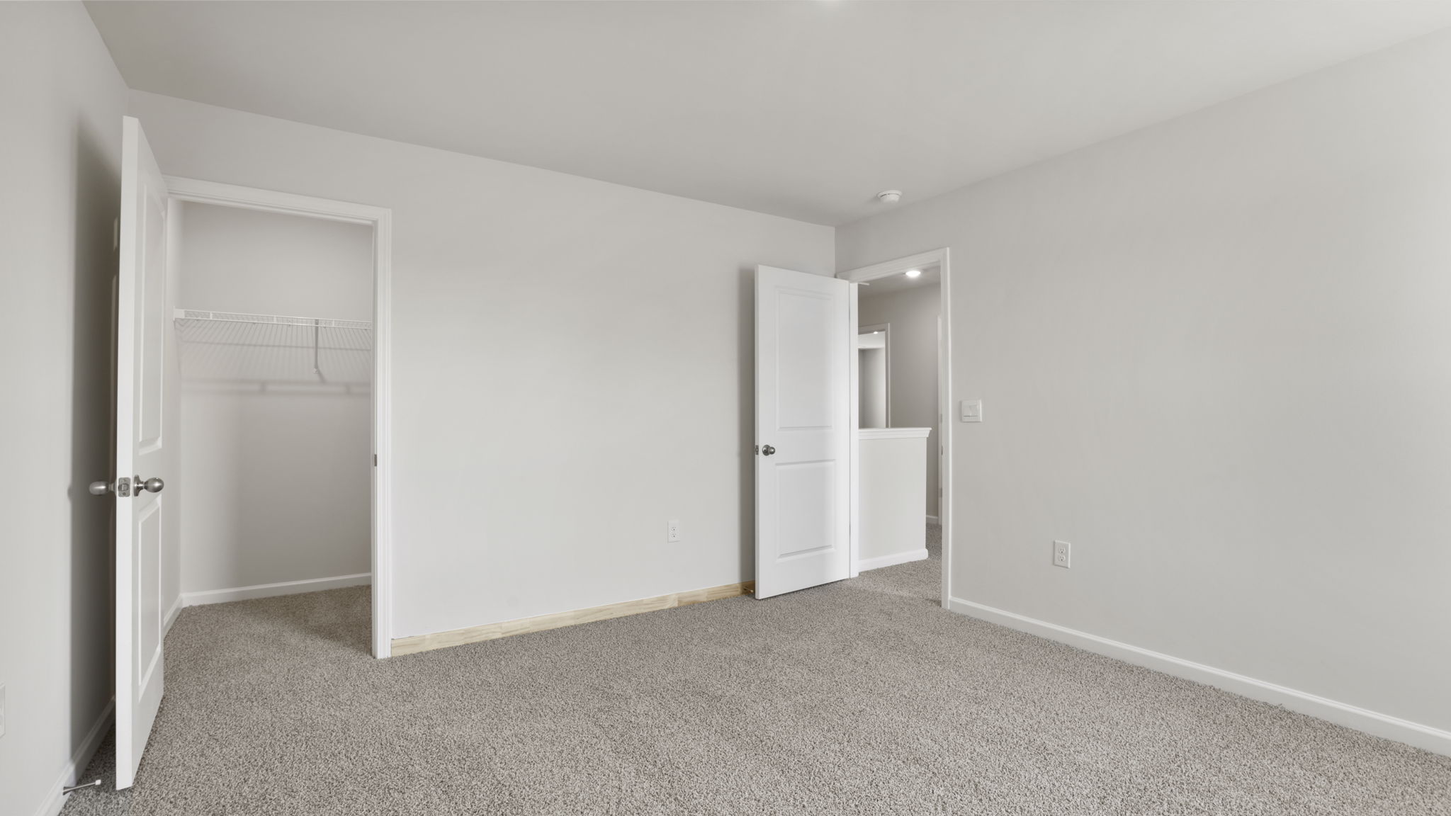 Bedroom with carpet and windows.