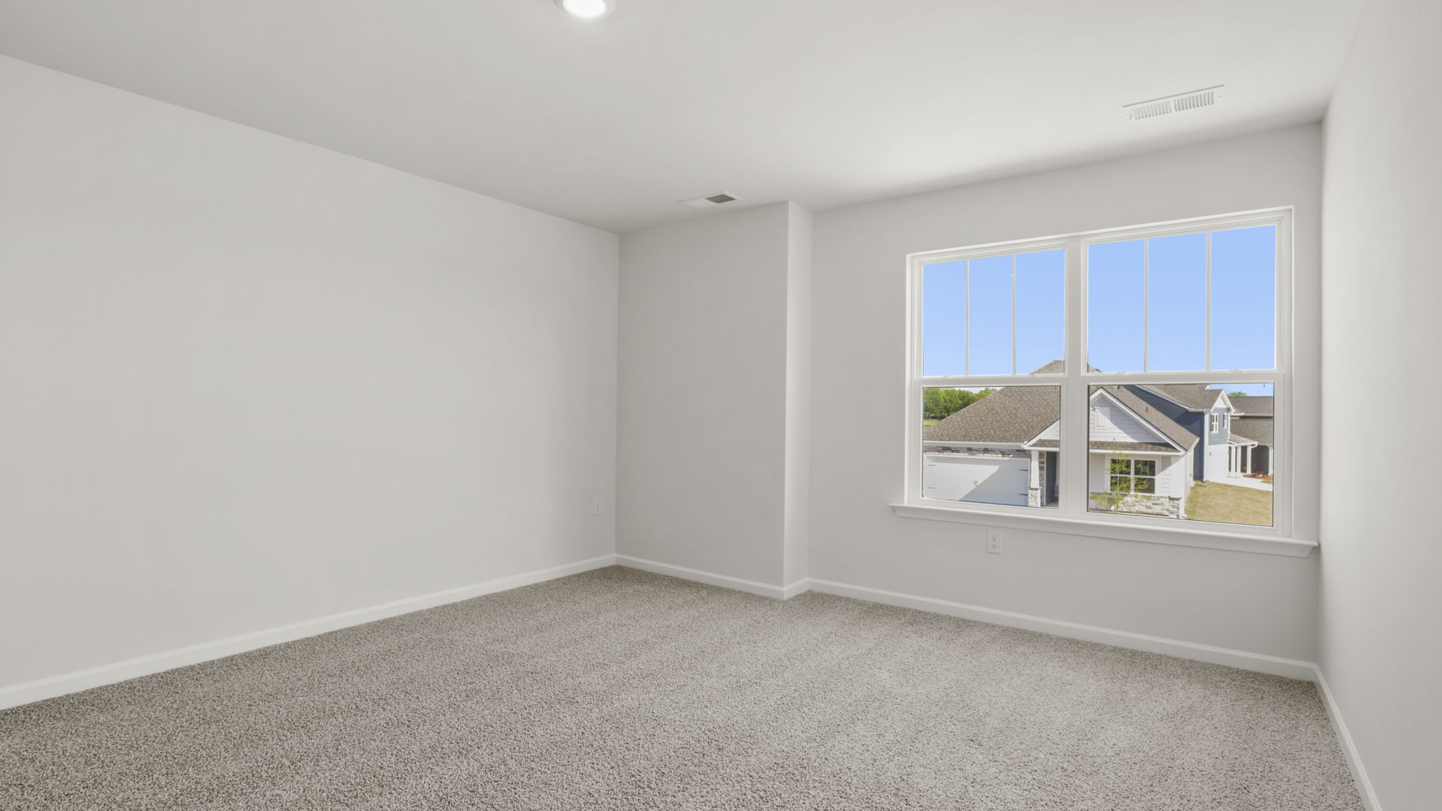 Bedroom with carpet and windows.