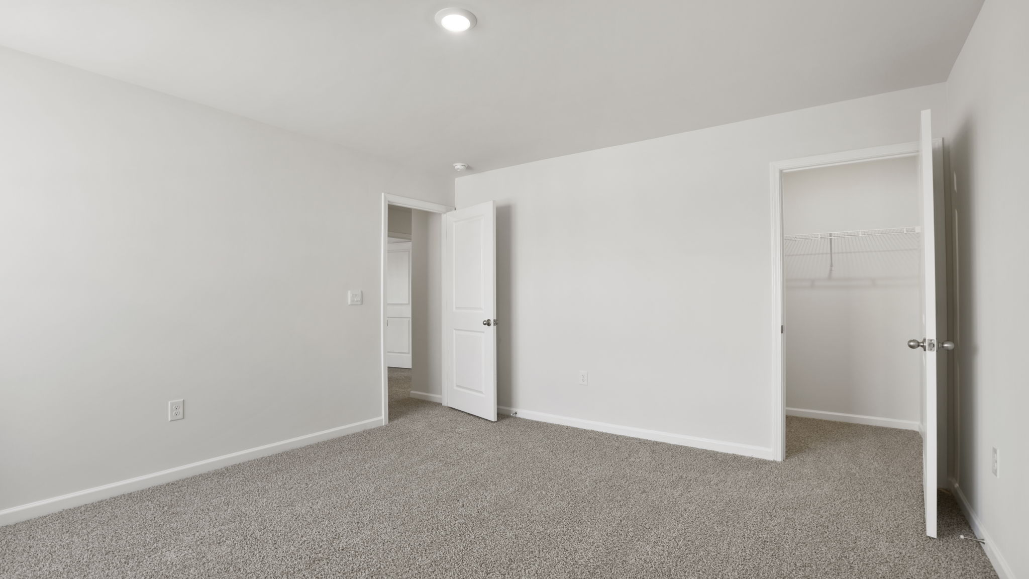 Bedroom with carpet and windows.