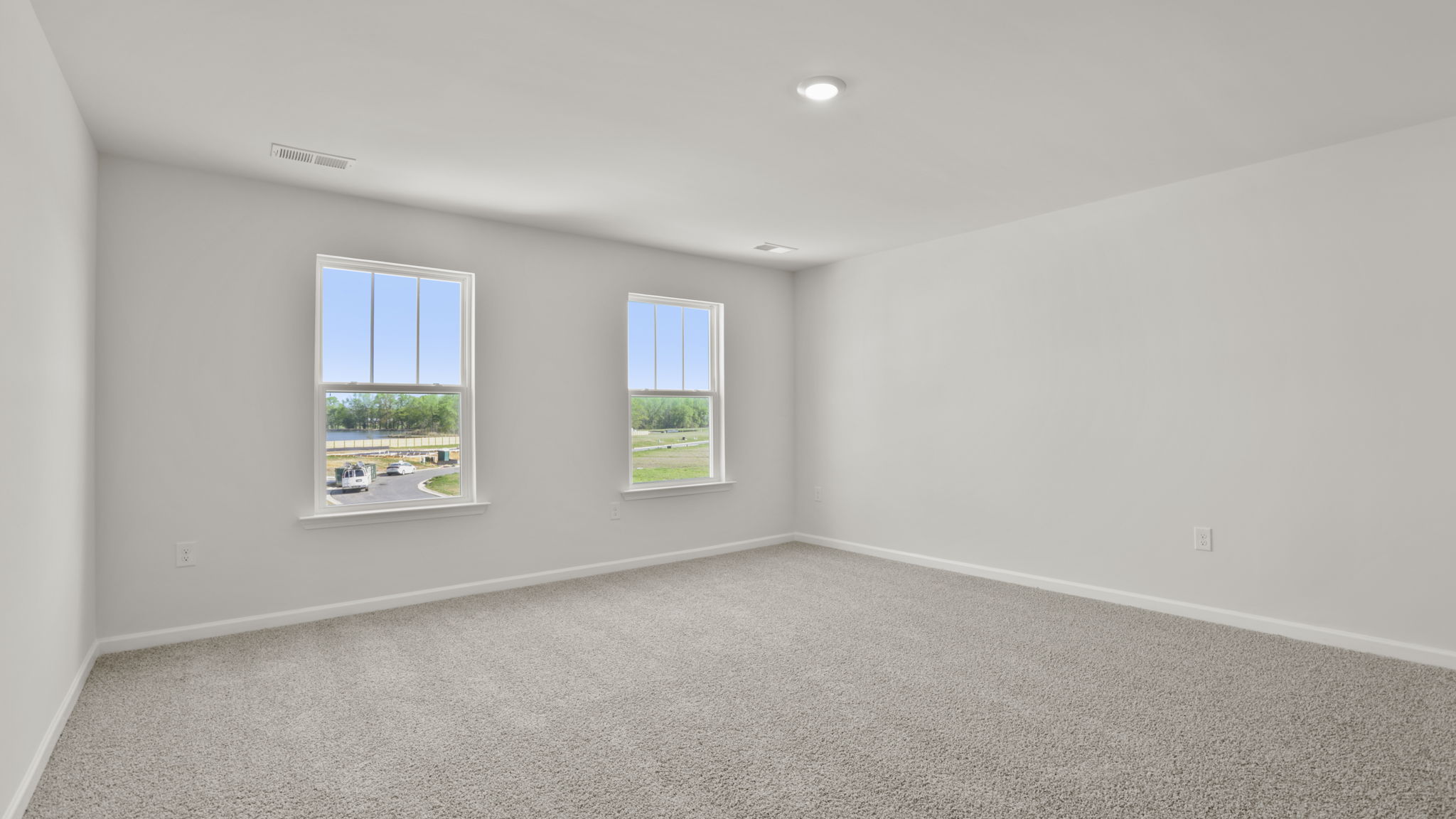 Bedroom with carpet and windows.