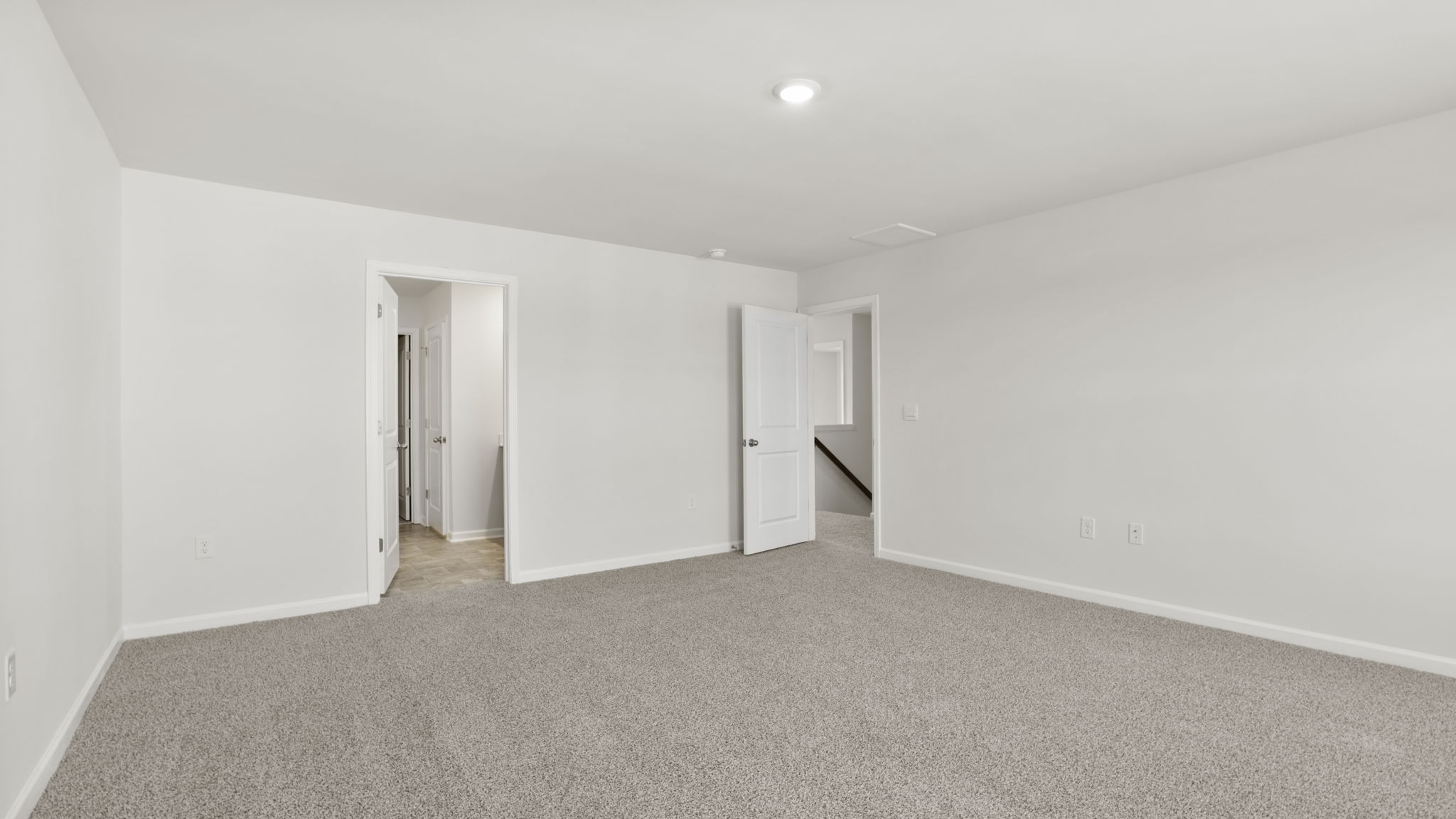 Bedroom with carpet and windows.