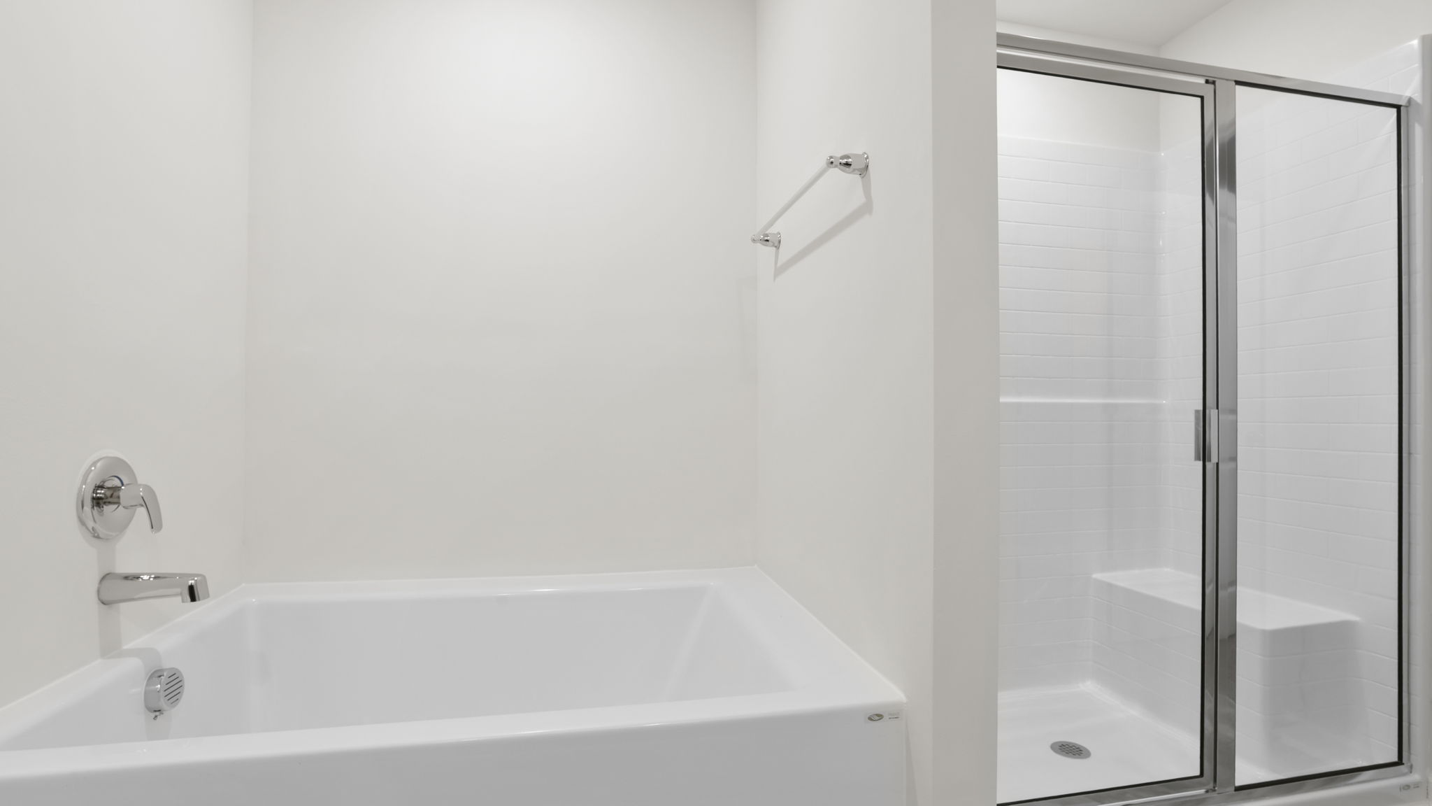 Bathroom with tub and walk in shower.