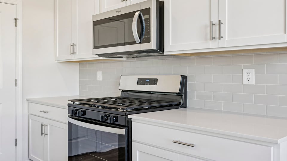 Kitchen hosts stainless steel appliances.