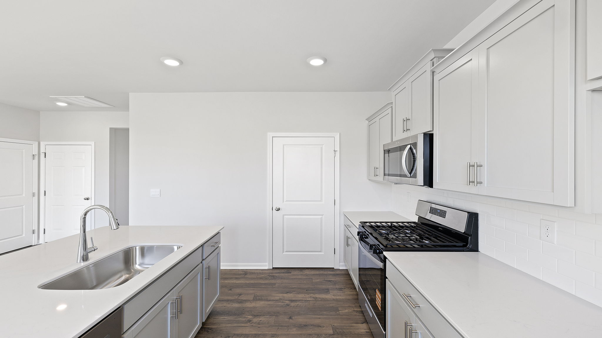 Kitchen with island and cabinets.