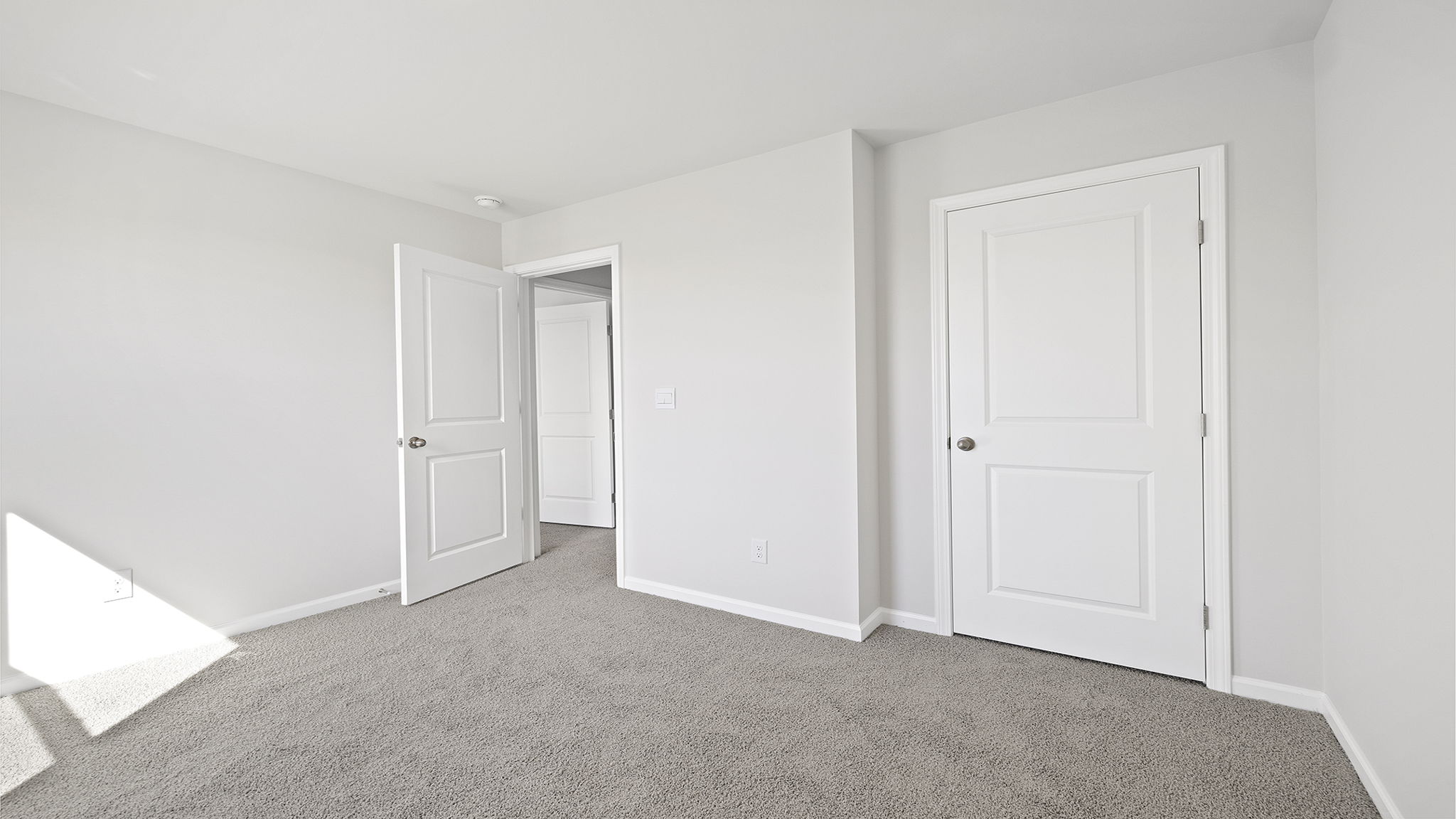 Bedroom with carpet and window.