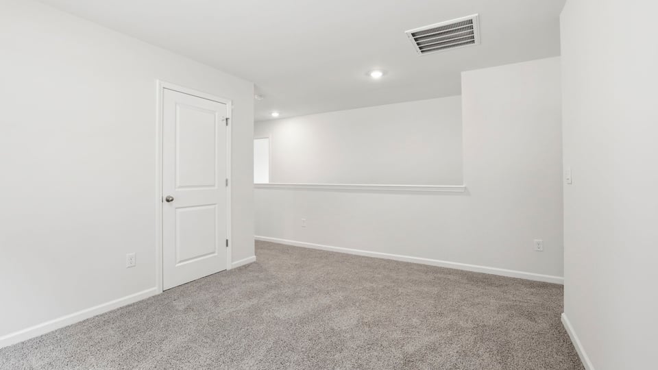Loft with carpet and window.