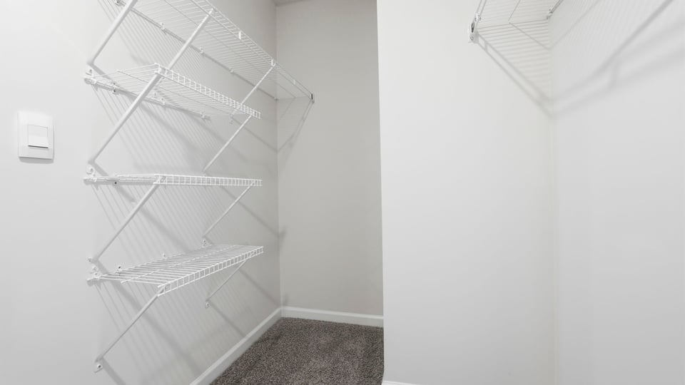 Primary closet with shelf.