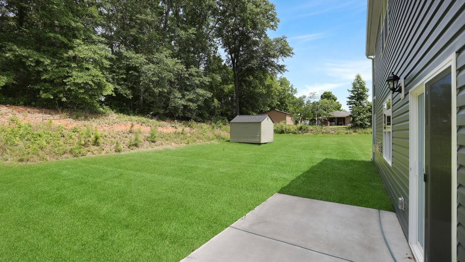 Back exterior with large backyard.