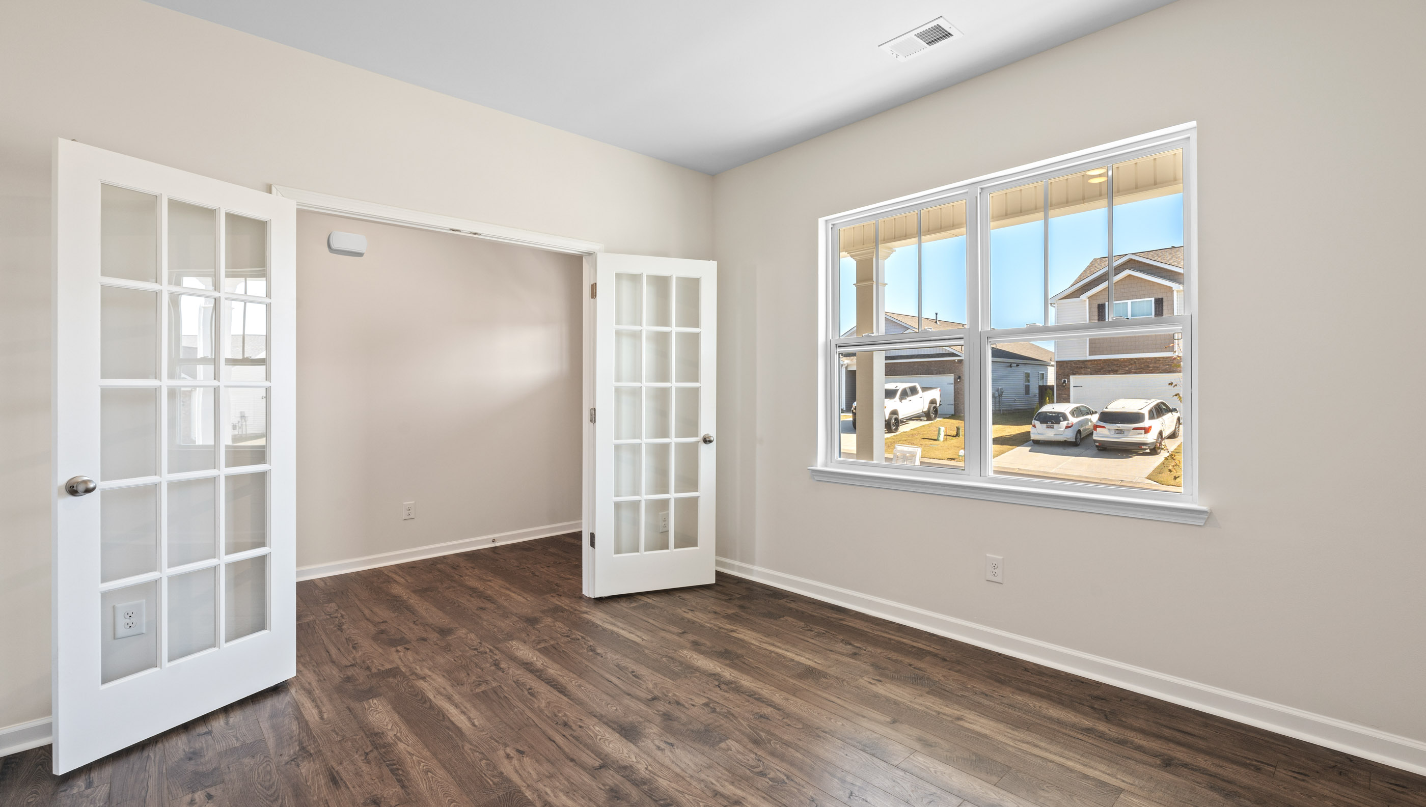 Study with large window and French doors.