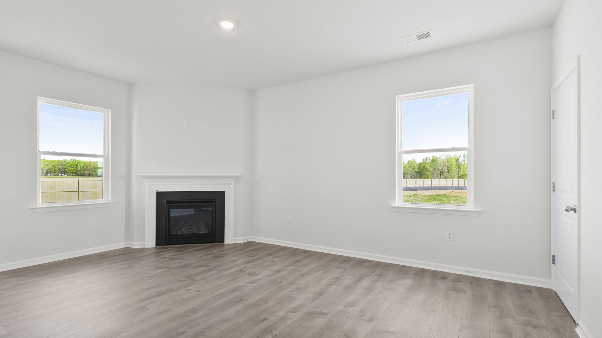 Family room with fireplace and windows.