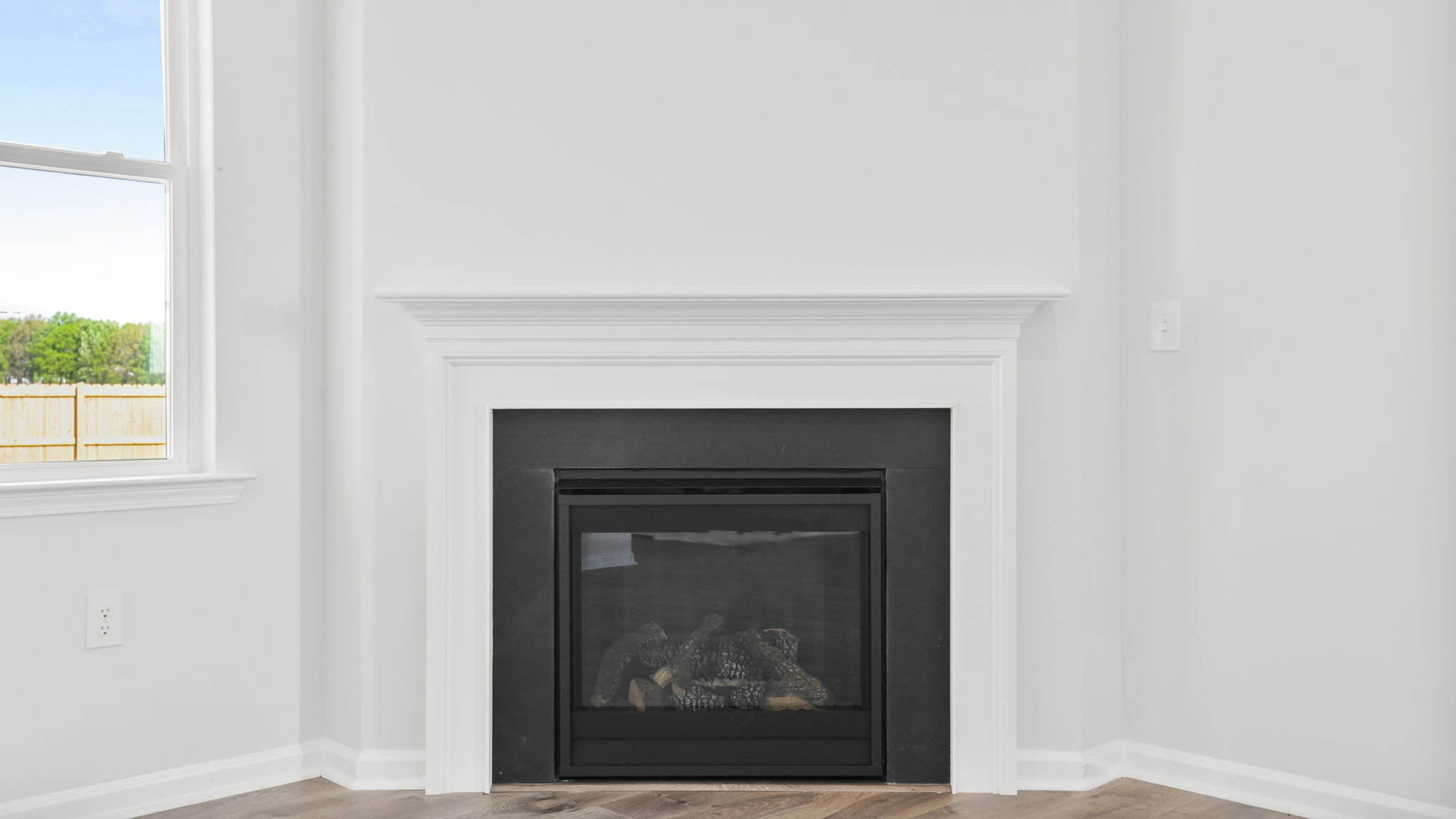 Family room with fireplace and windows.