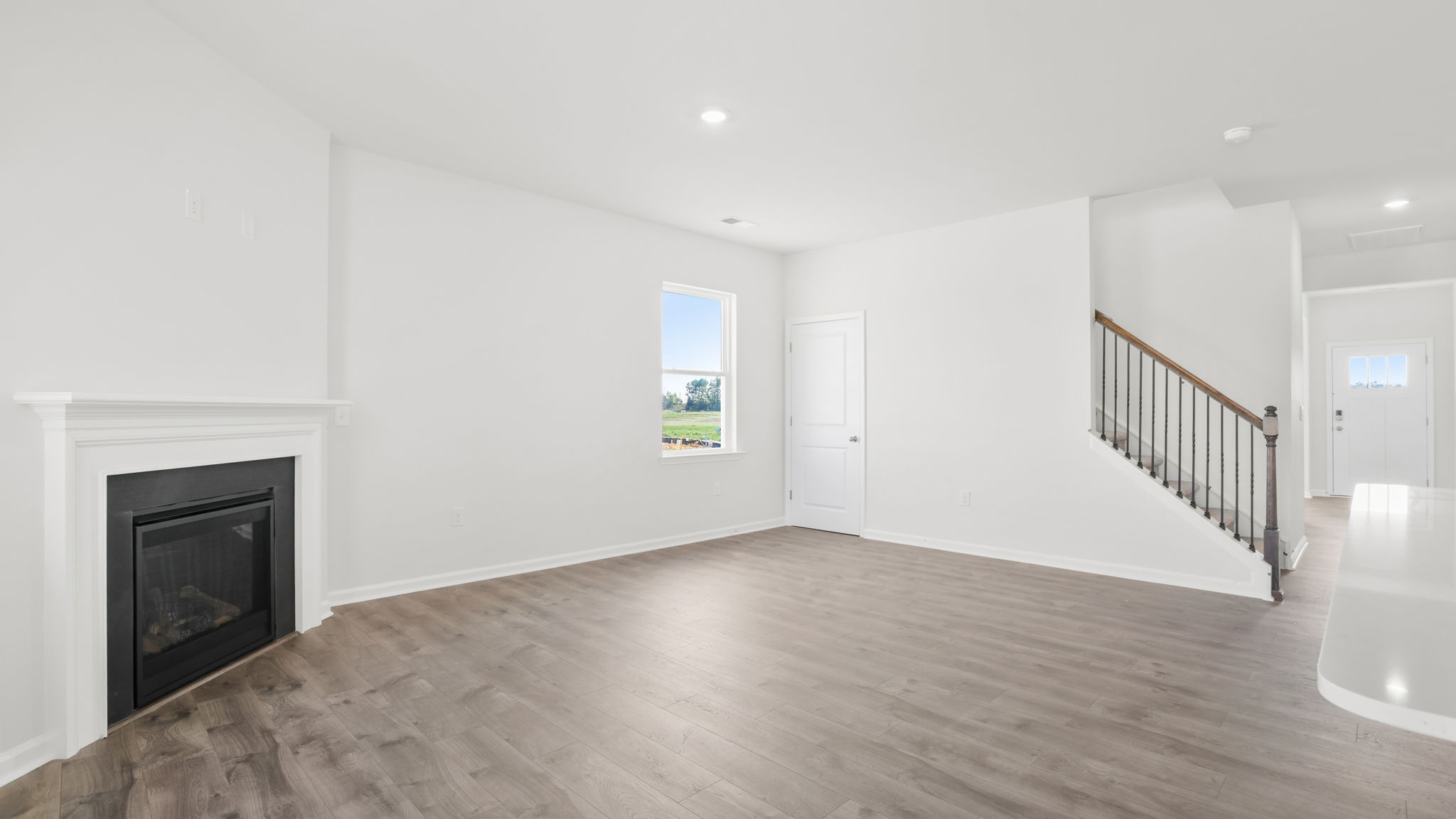 Family room with fireplace and windows.