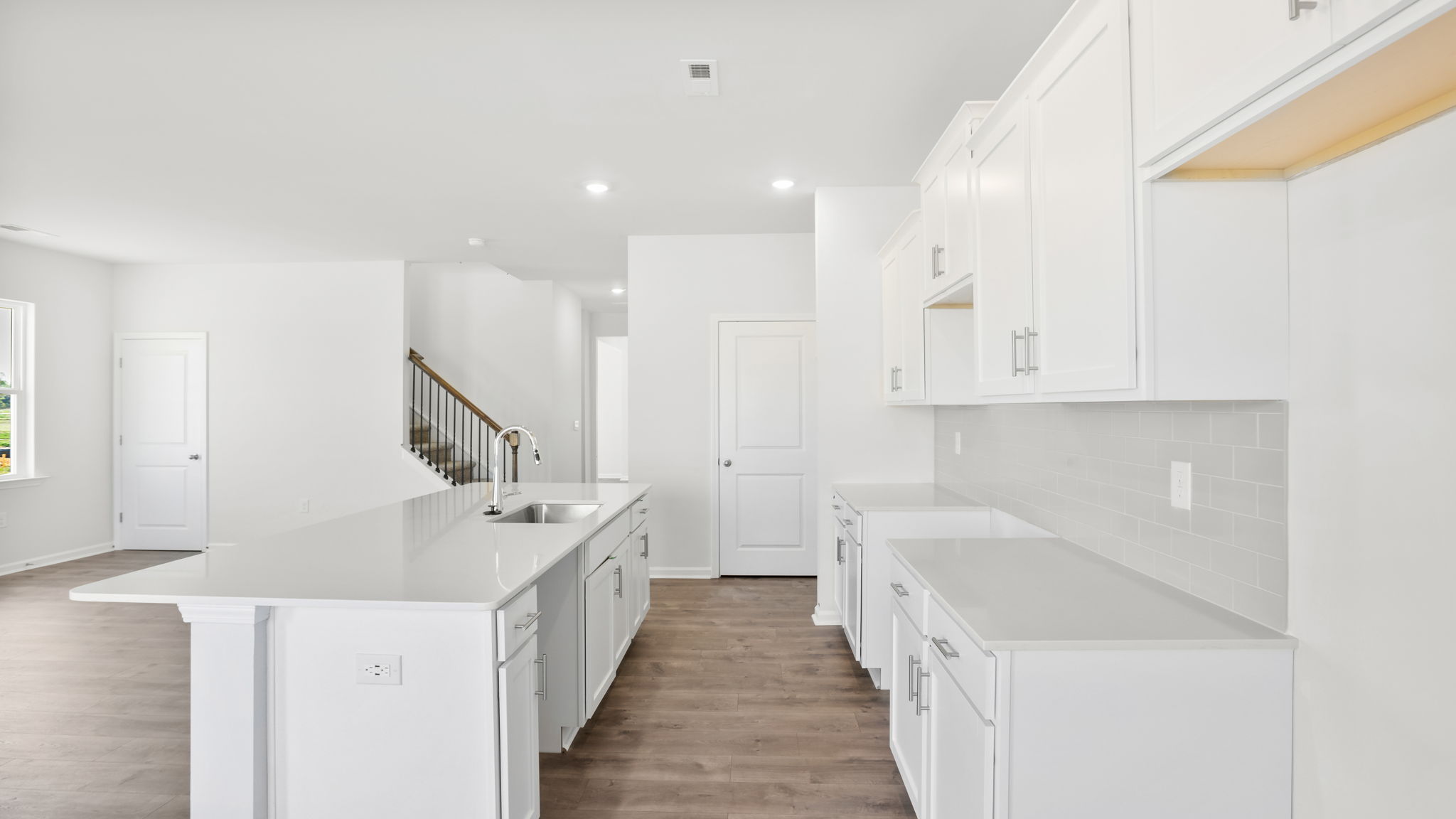 Kitchen and island with stainless steel appliances.
