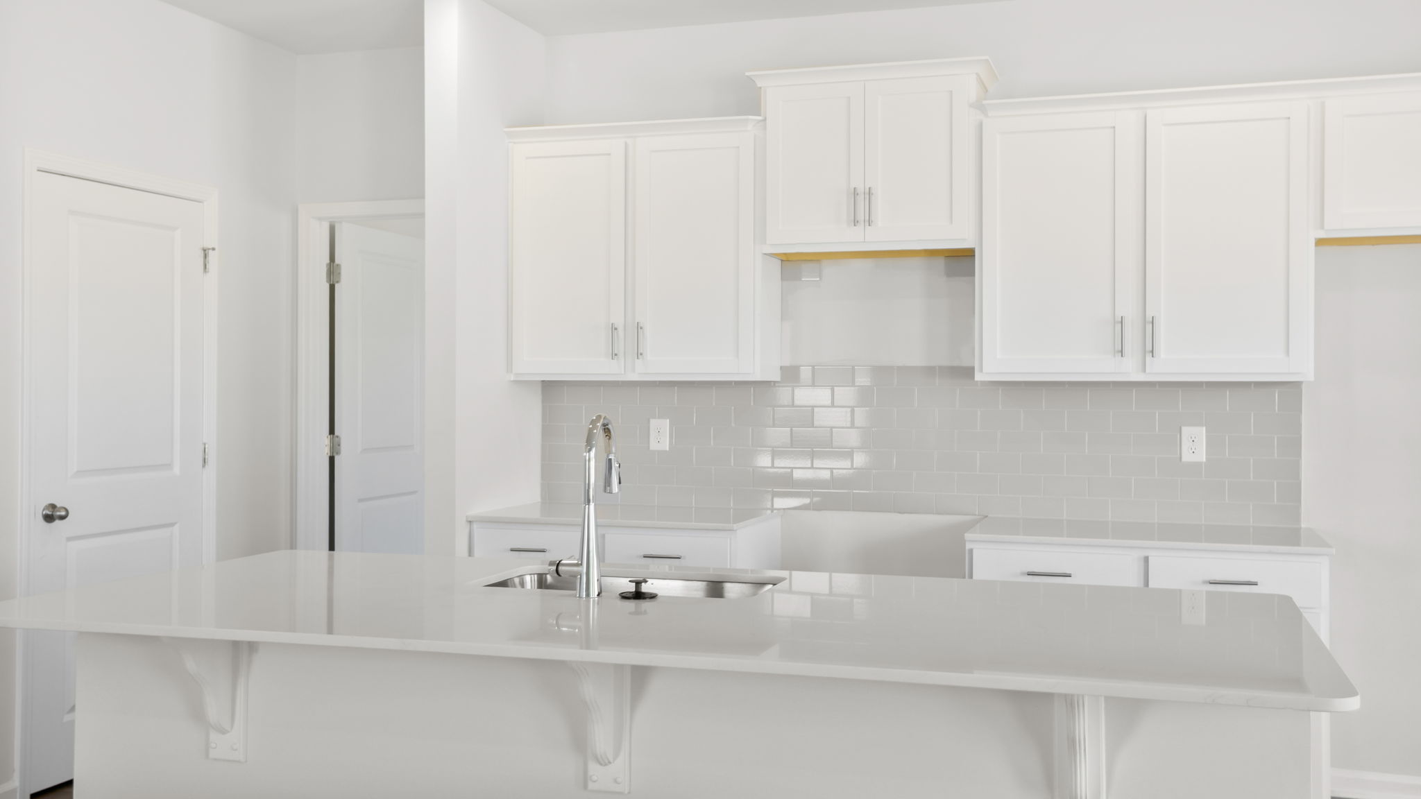 Kitchen and island with stainless steel appliances.