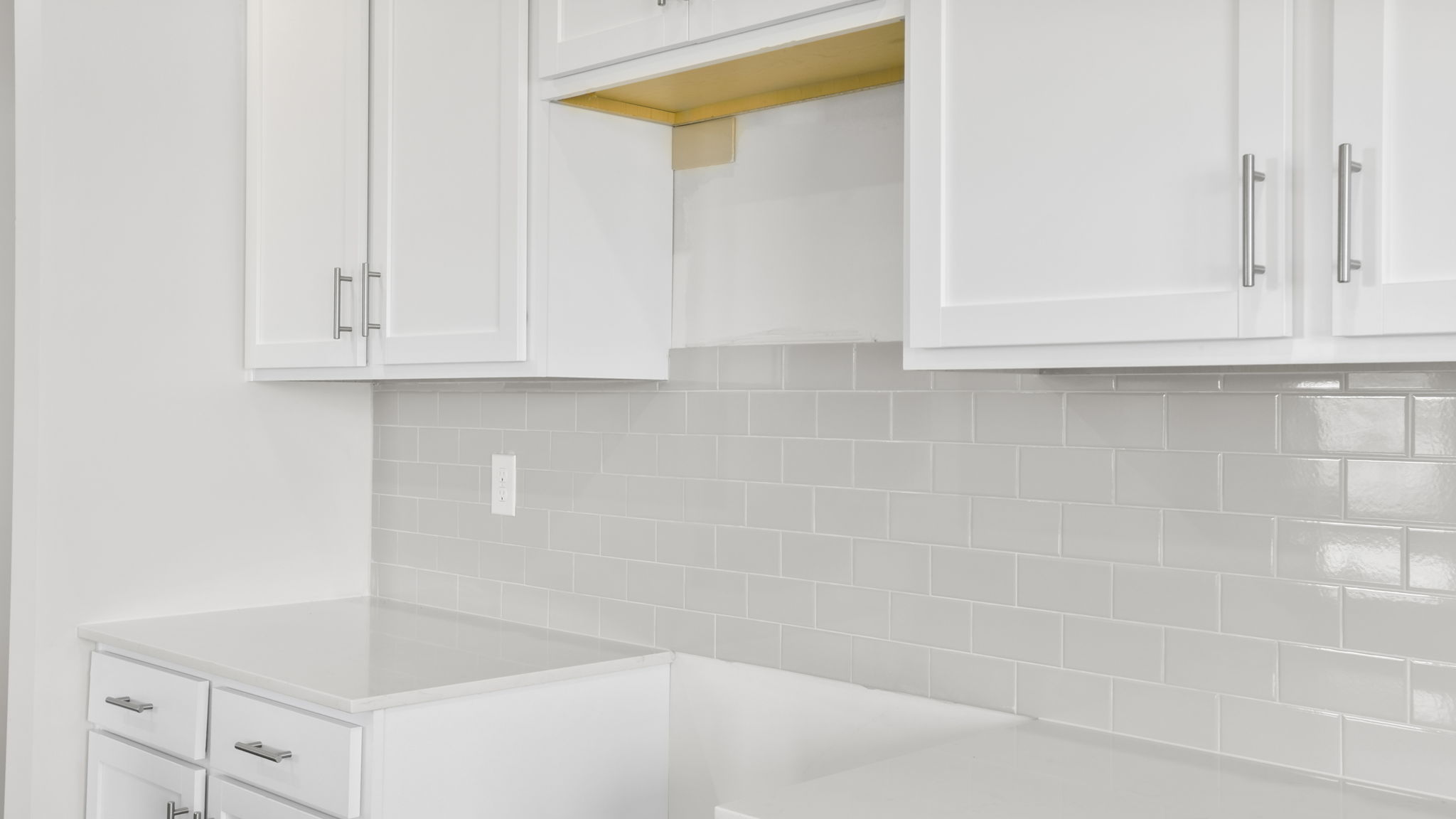 Kitchen and island with stainless steel appliances.