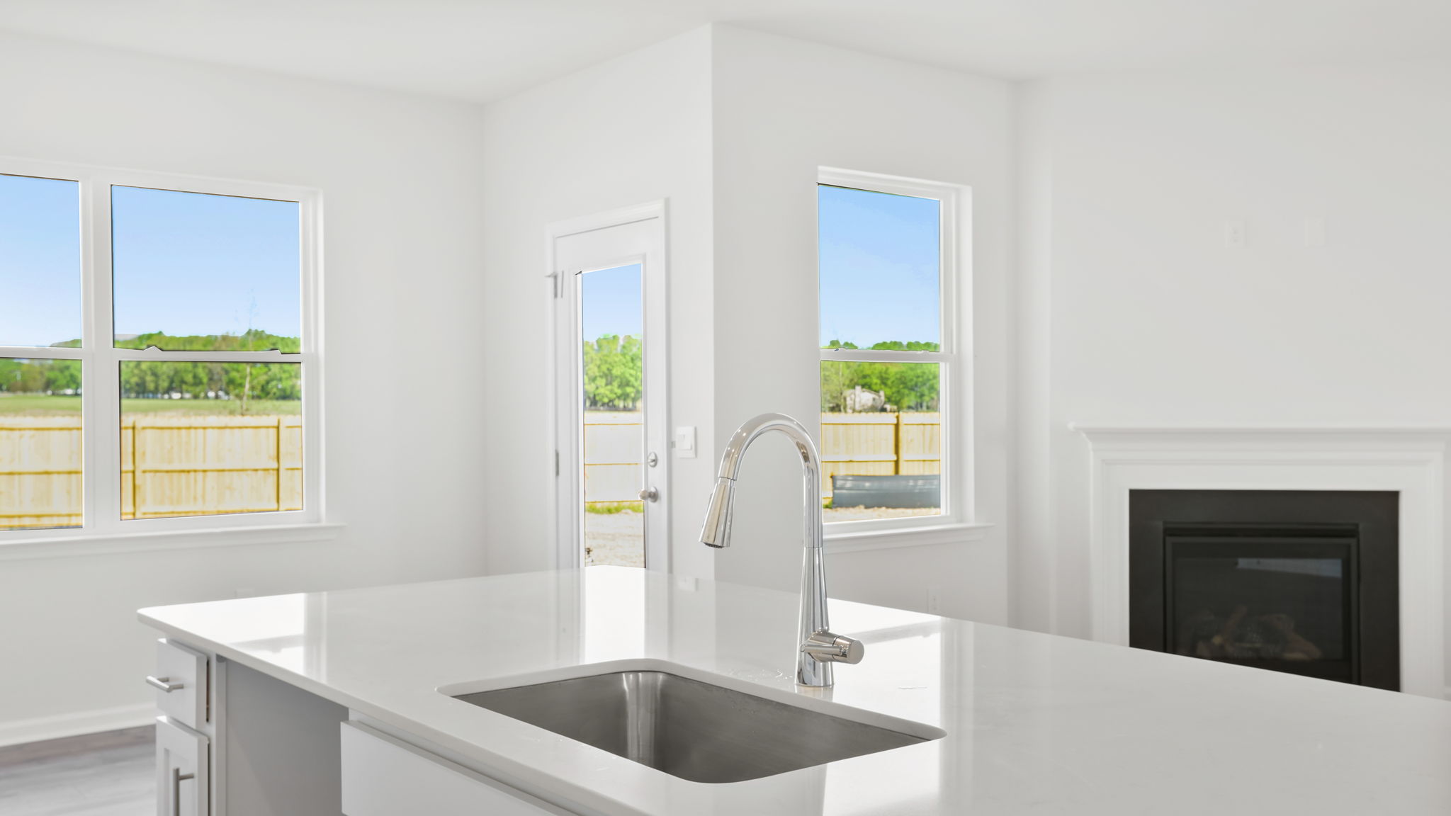 Kitchen and island with stainless steel appliances.
