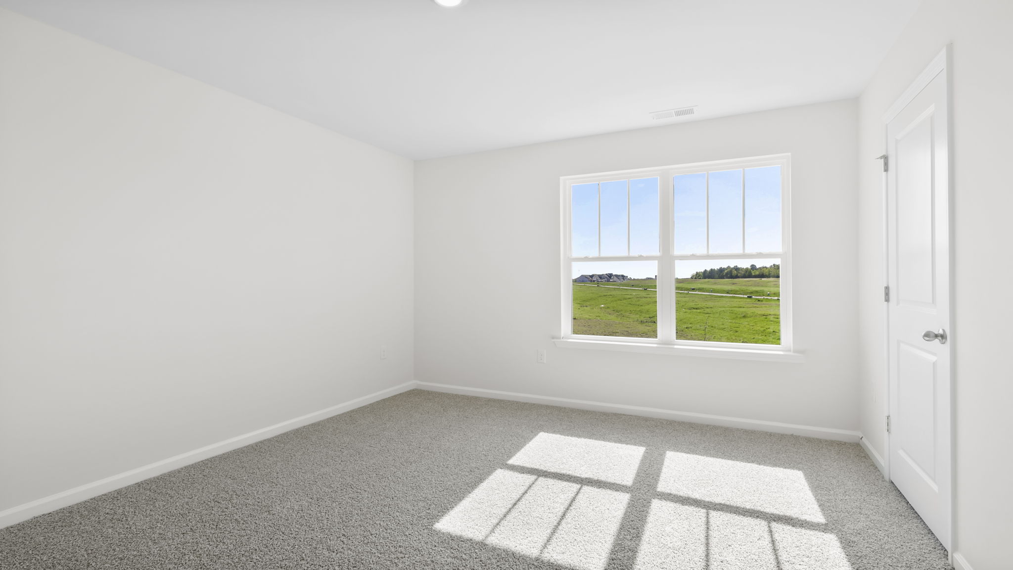 Bedroom with carpet and window.