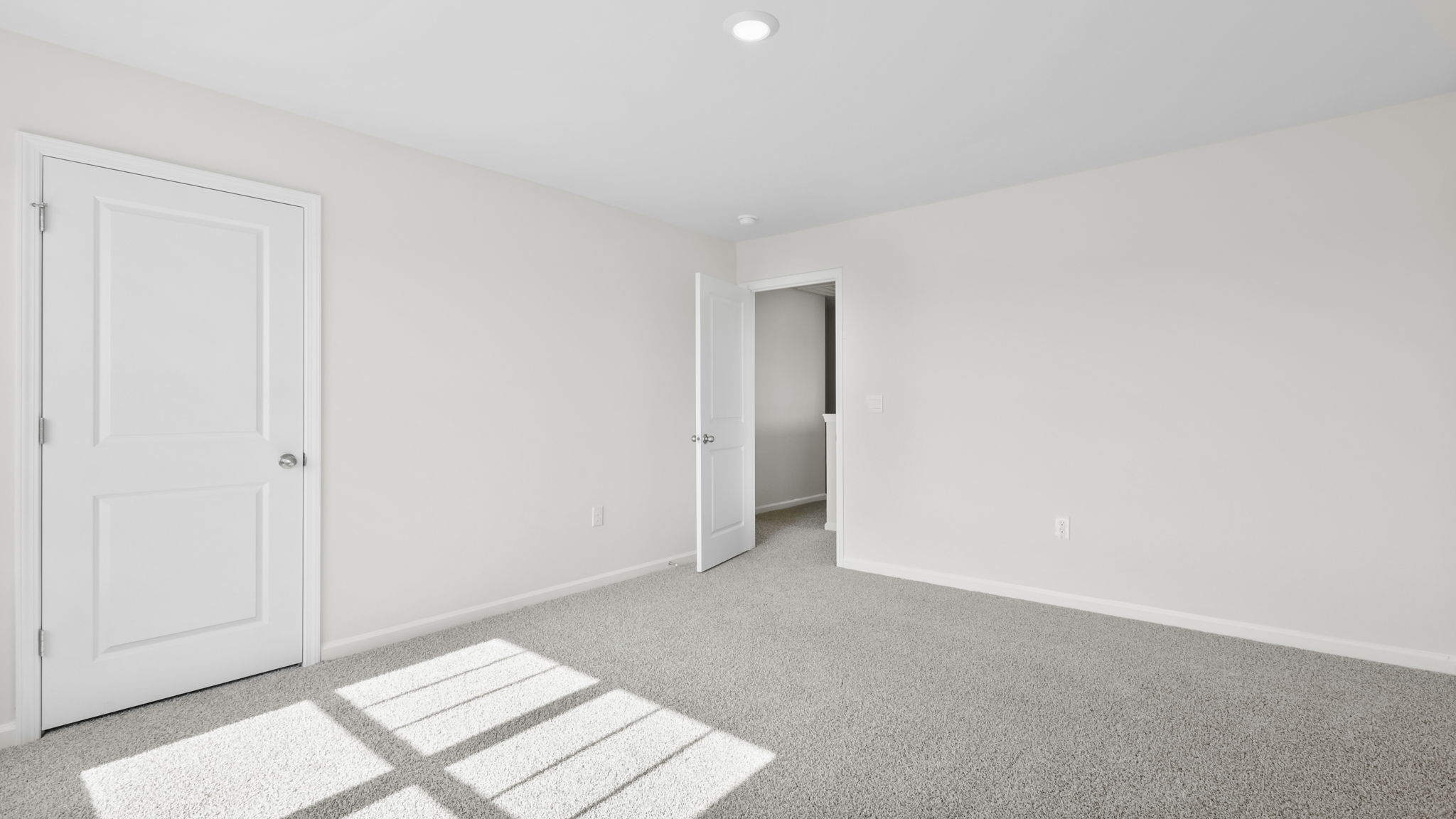 Bedroom with carpet and window.