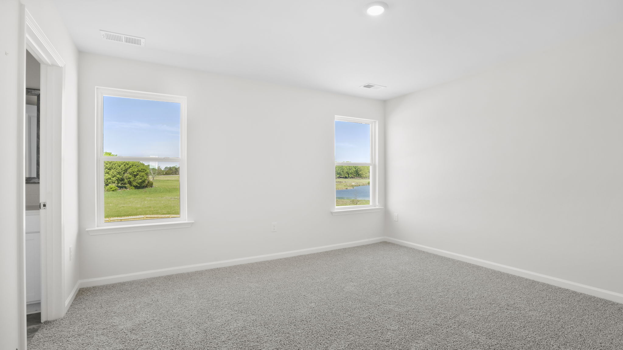Bedroom with carpet and window.