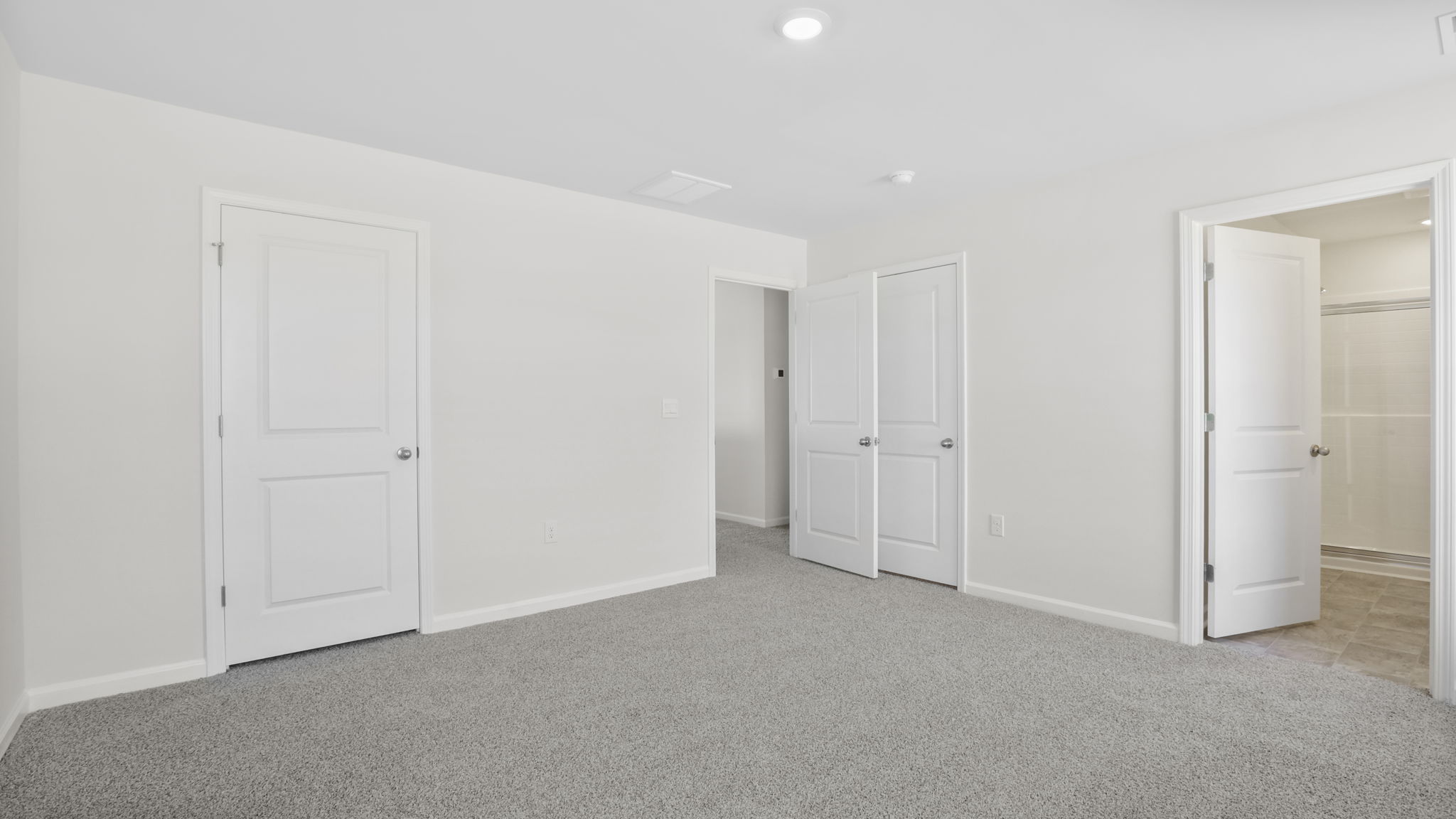 Bedroom with carpet and window.