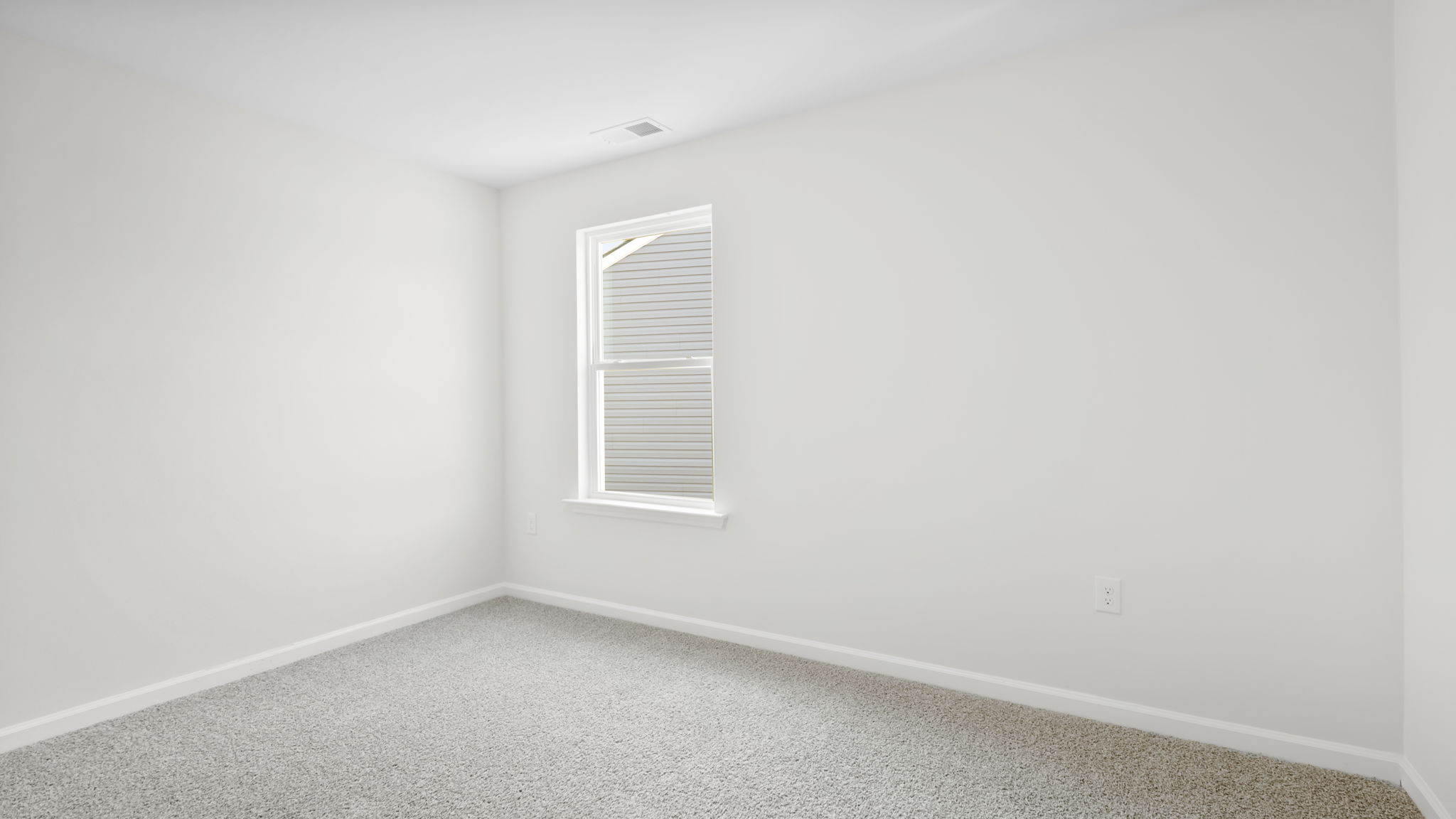 Bedroom with carpet and window.