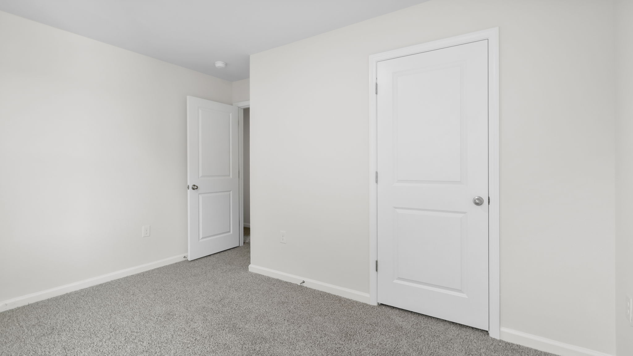 Bedroom with carpet and window.