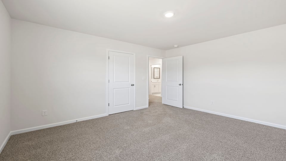 Bedroom with window and carpet.