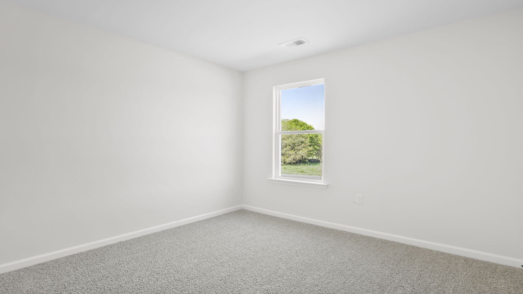 Bedroom with carpet and window.