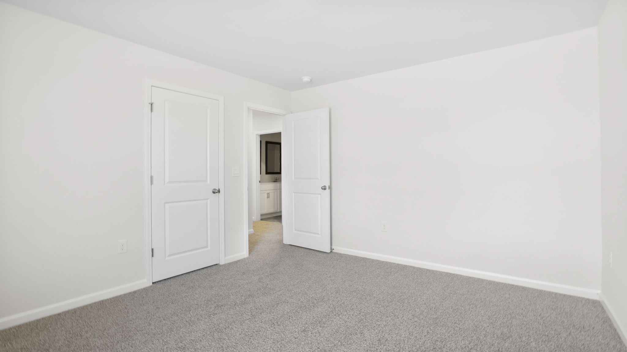 Bedroom with carpet and window.