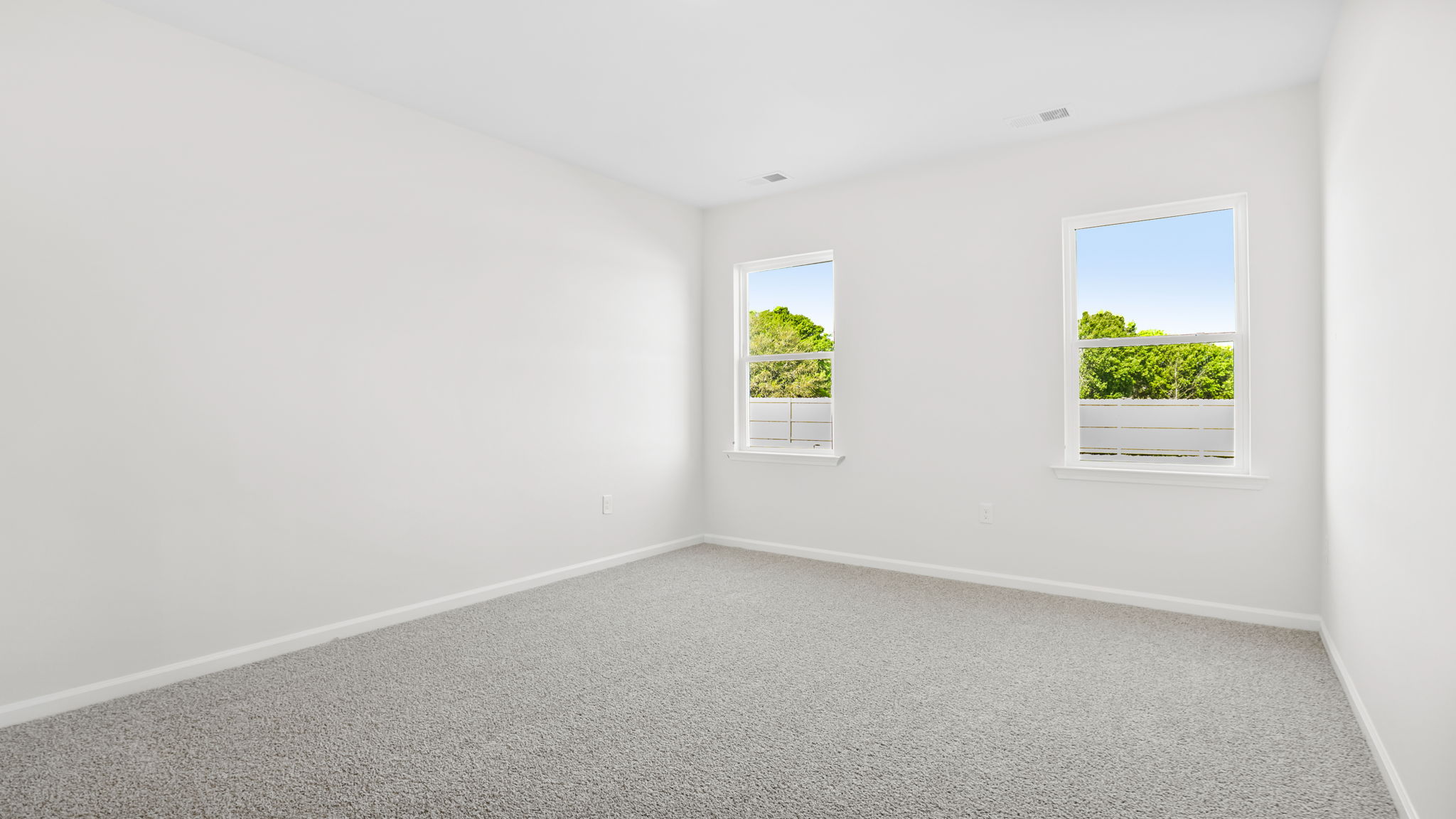 Bedroom with carpet and window.
