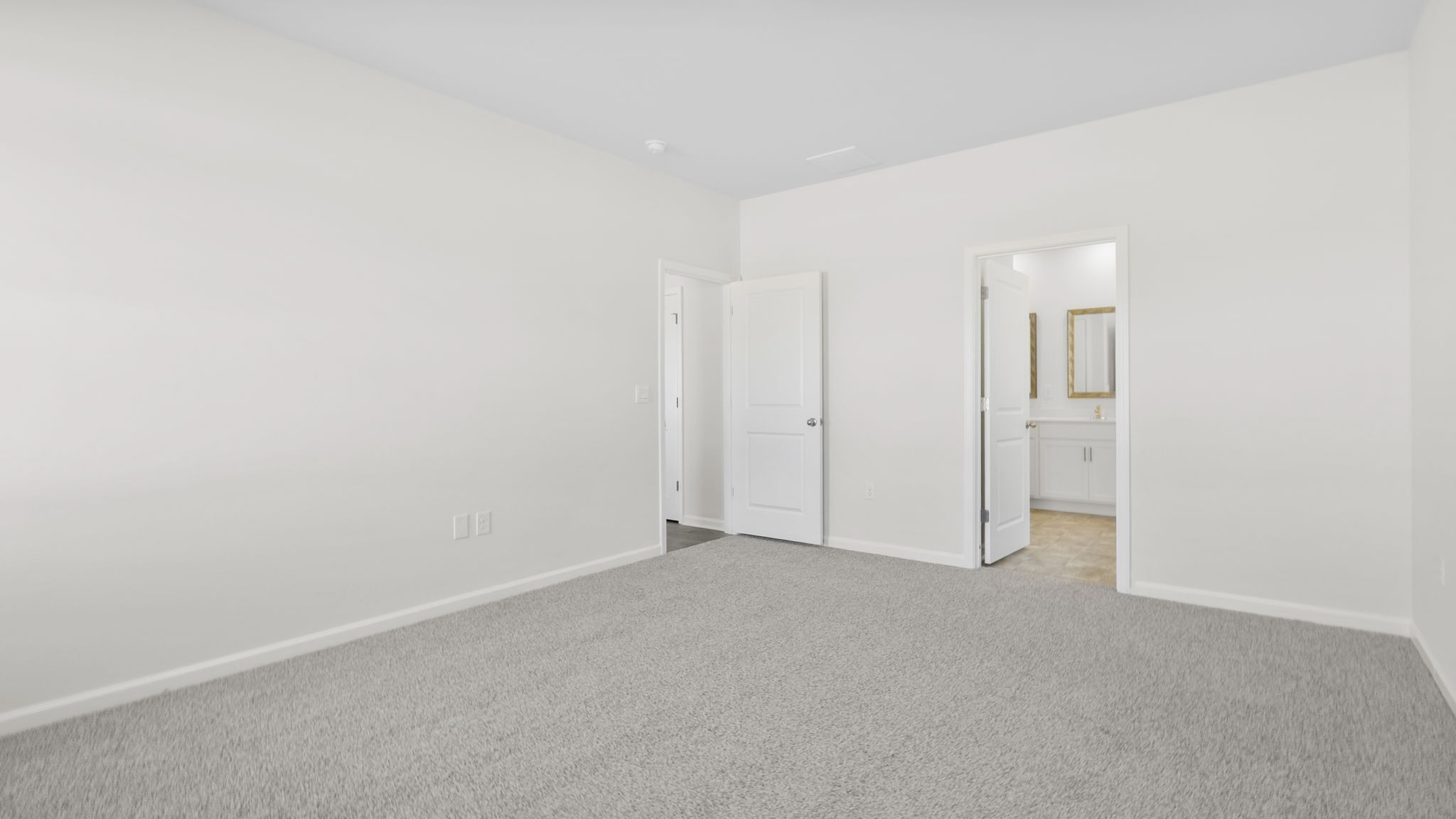 Bedroom with carpet and window.