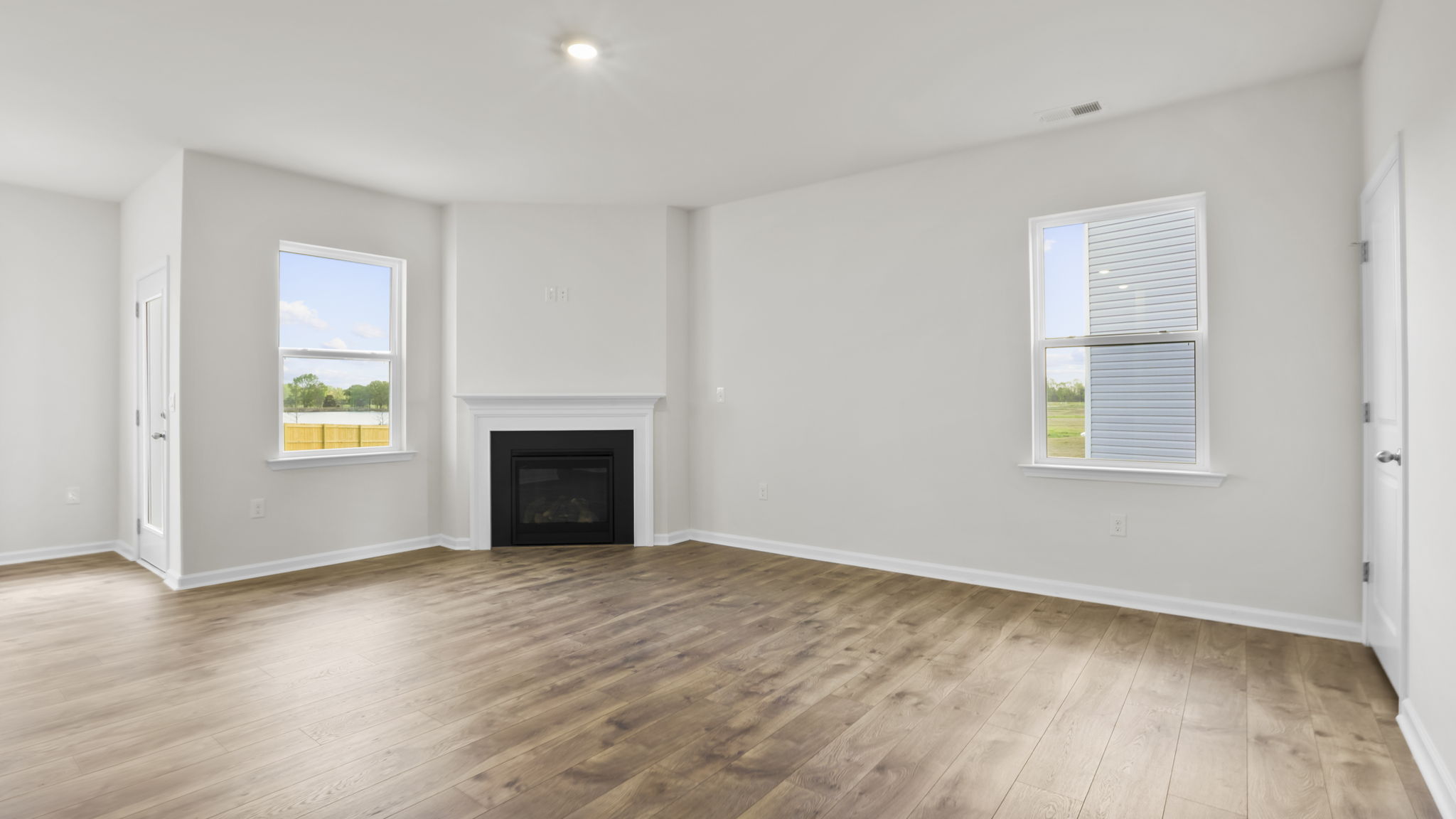 Family room with fireplace and windows.