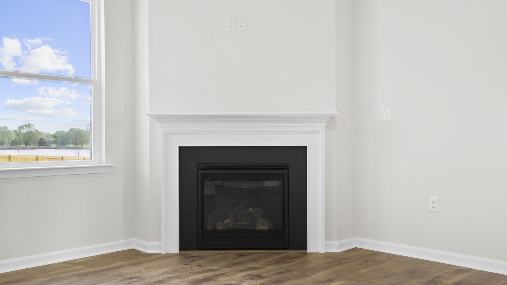 Family room with fireplace and windows.