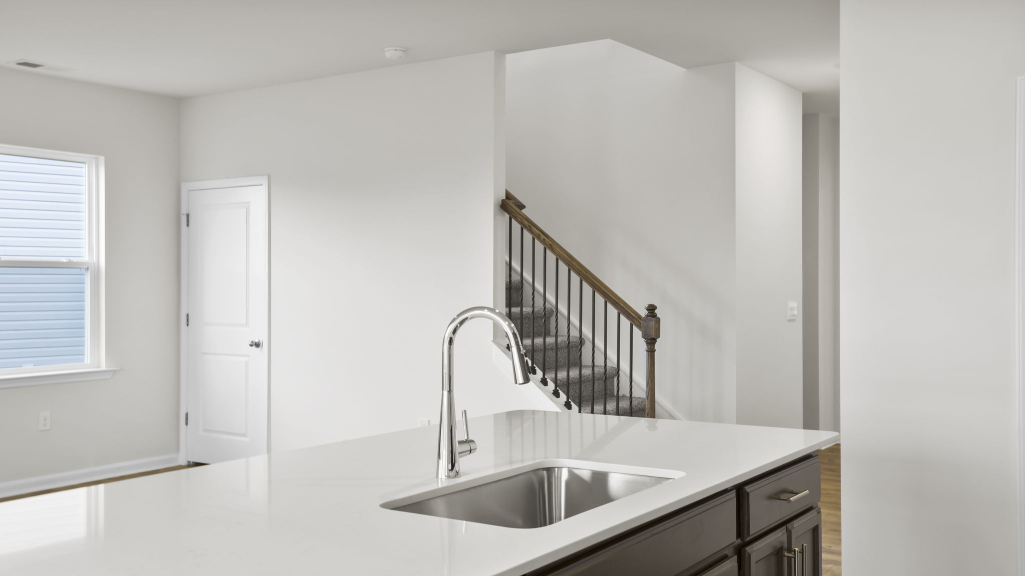 Kitchen and island with stainless steel appliances.