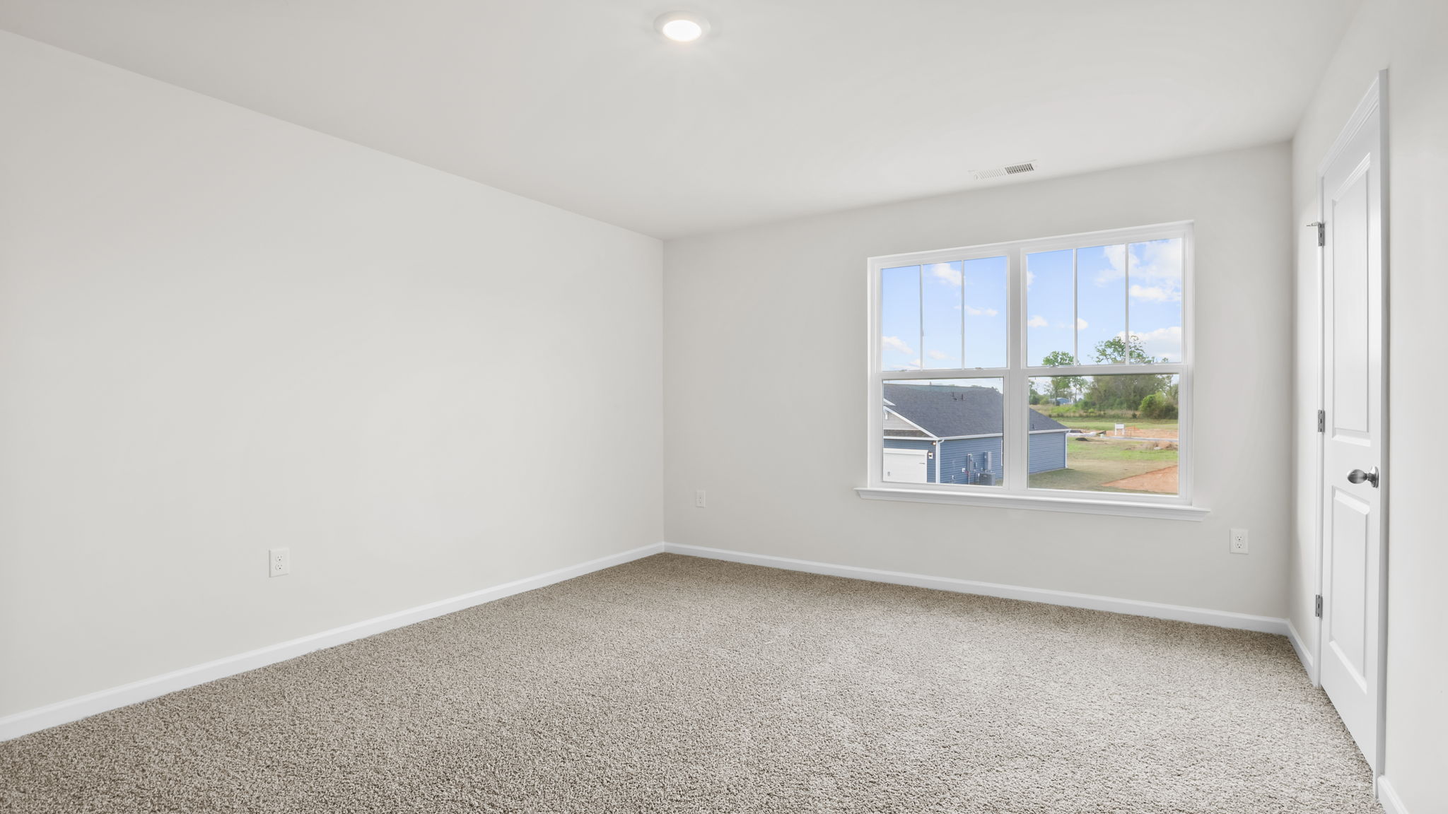 Bedroom with carpet and window.