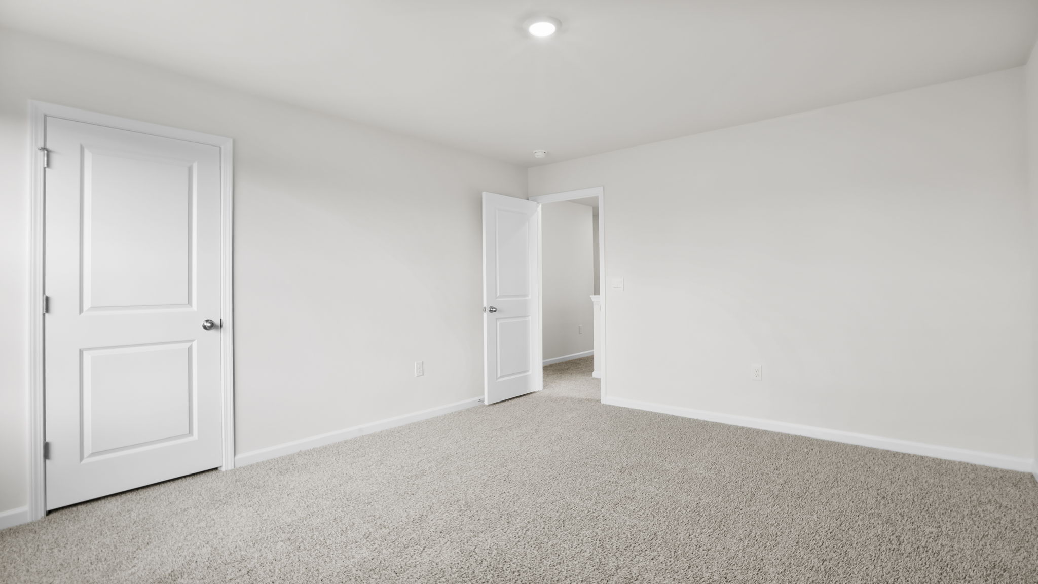 Bedroom with carpet and window.