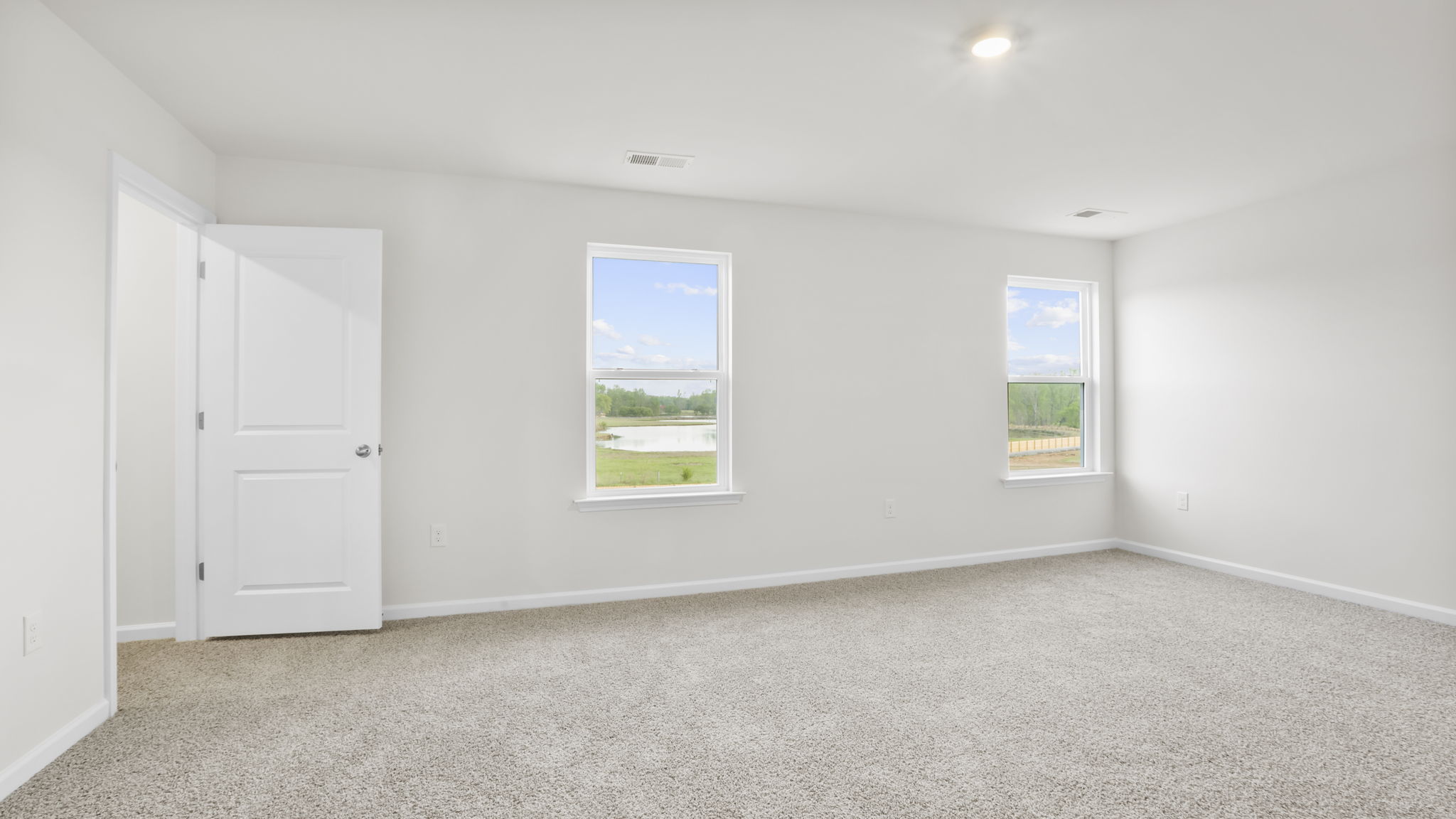 Bedroom with carpet and window.