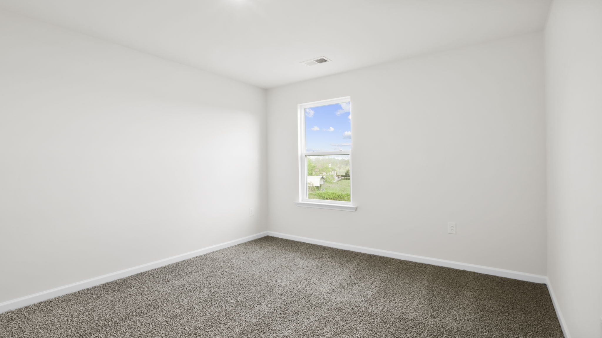 Bedroom with carpet and window.