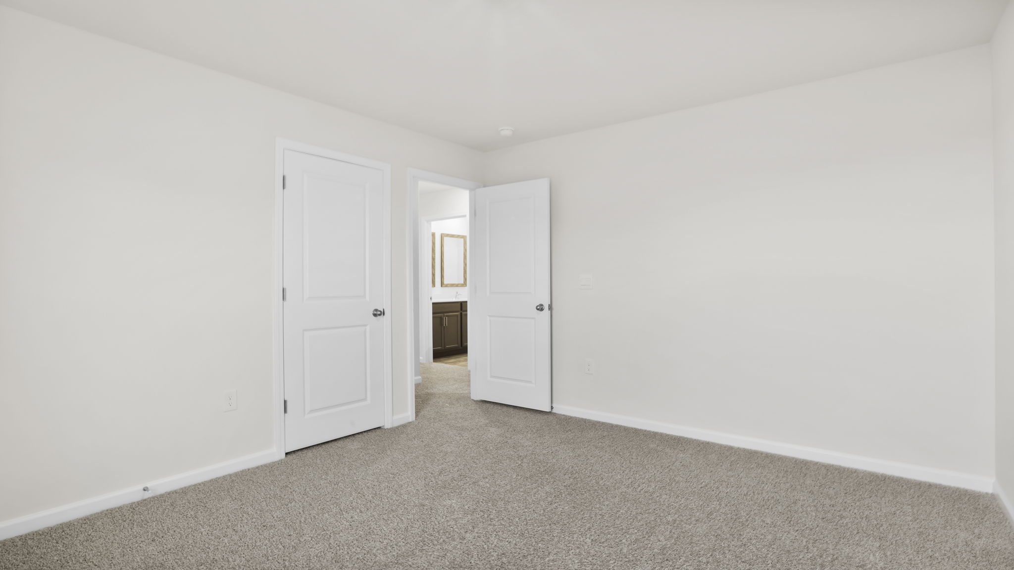 Bedroom with carpet and window.