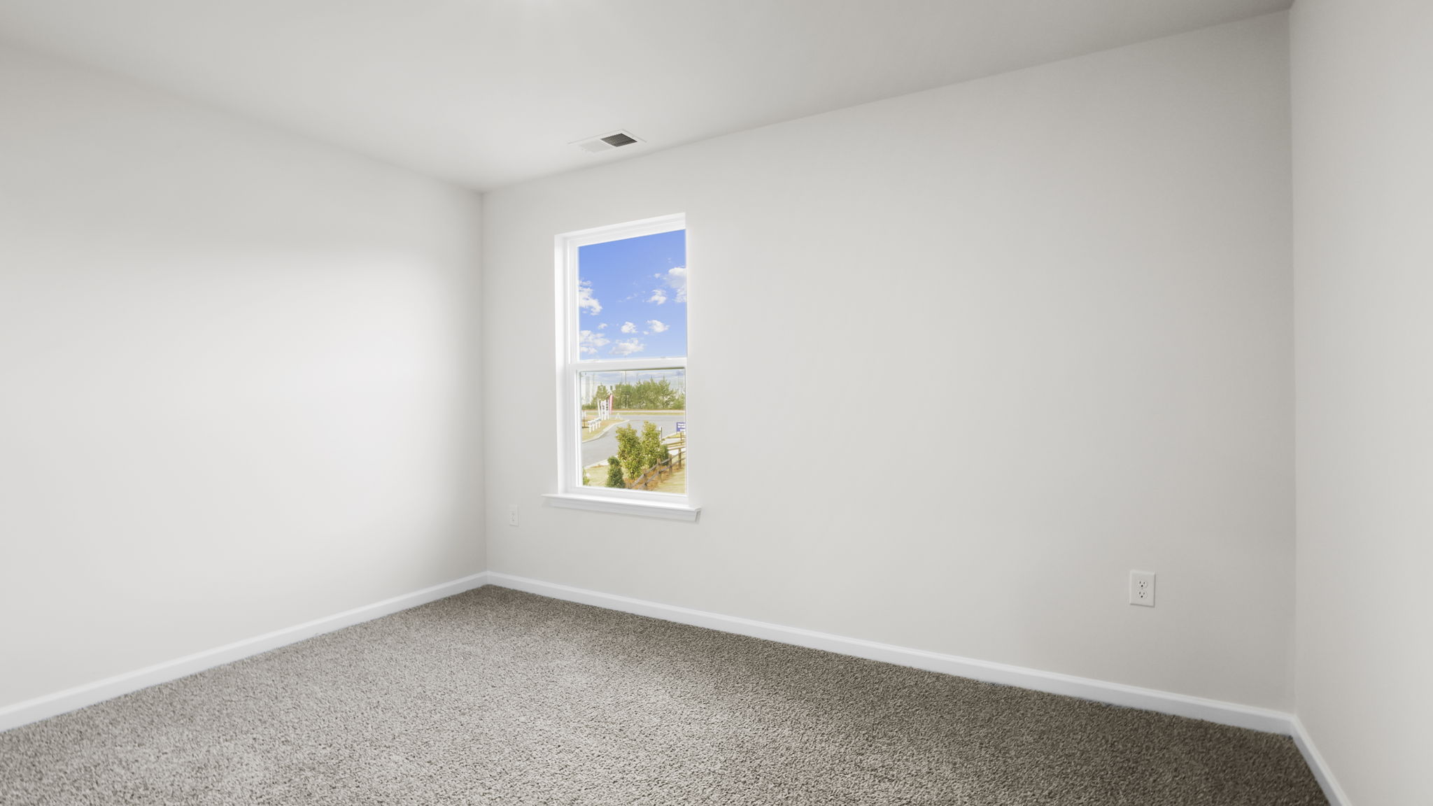 Bedroom with carpet and window.