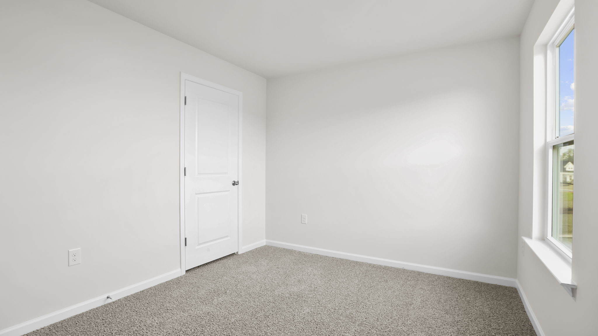 Bedroom with carpet and window.