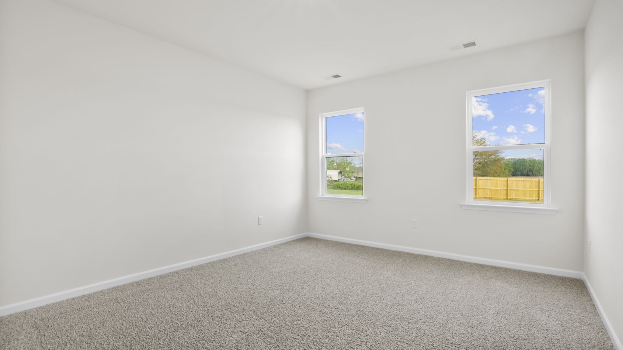 Bedroom with carpet and window.