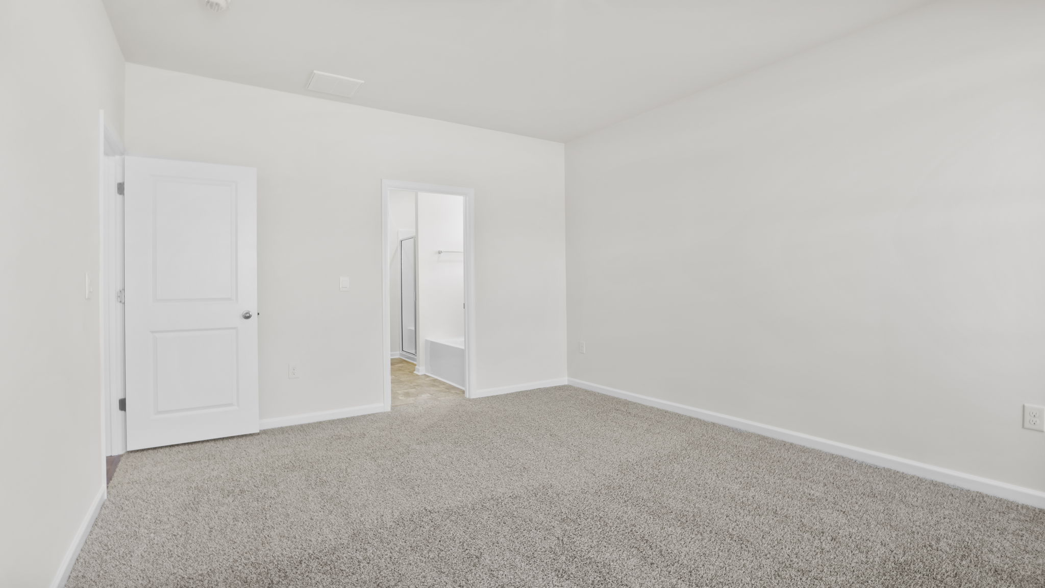 Bedroom with carpet and window.