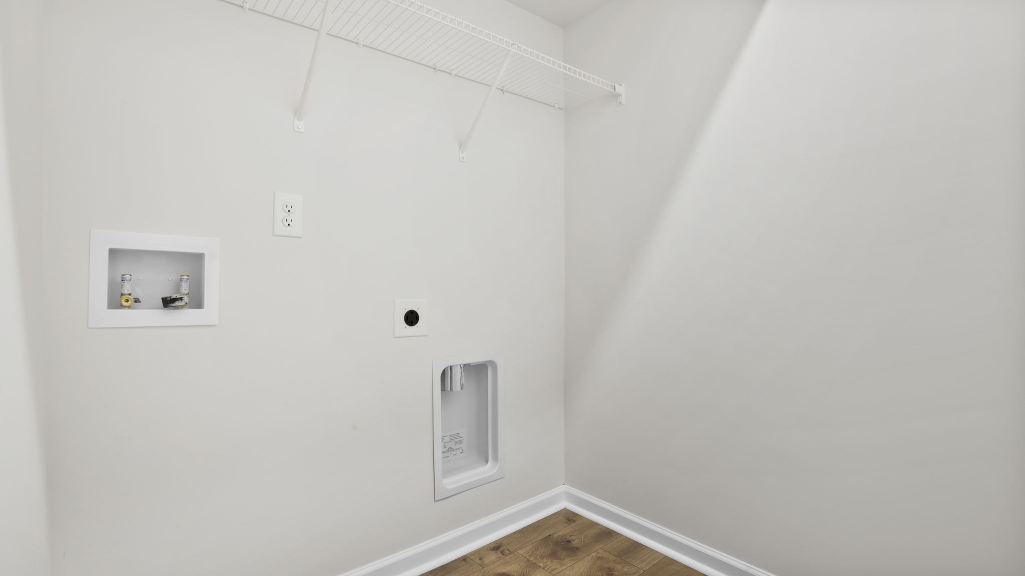 Laundry room with hanging storage racks.