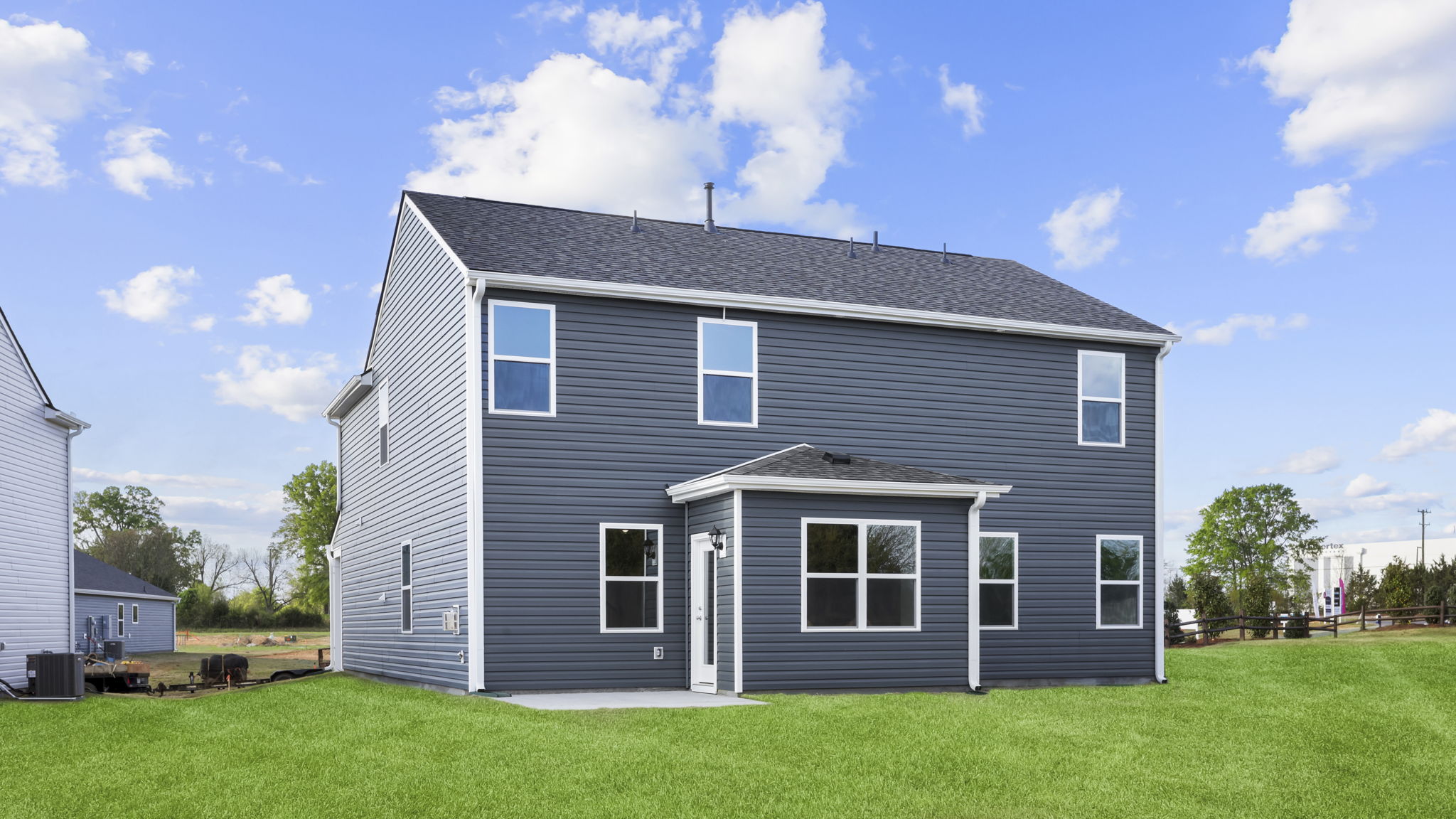 Back exterior of home with large backyard.