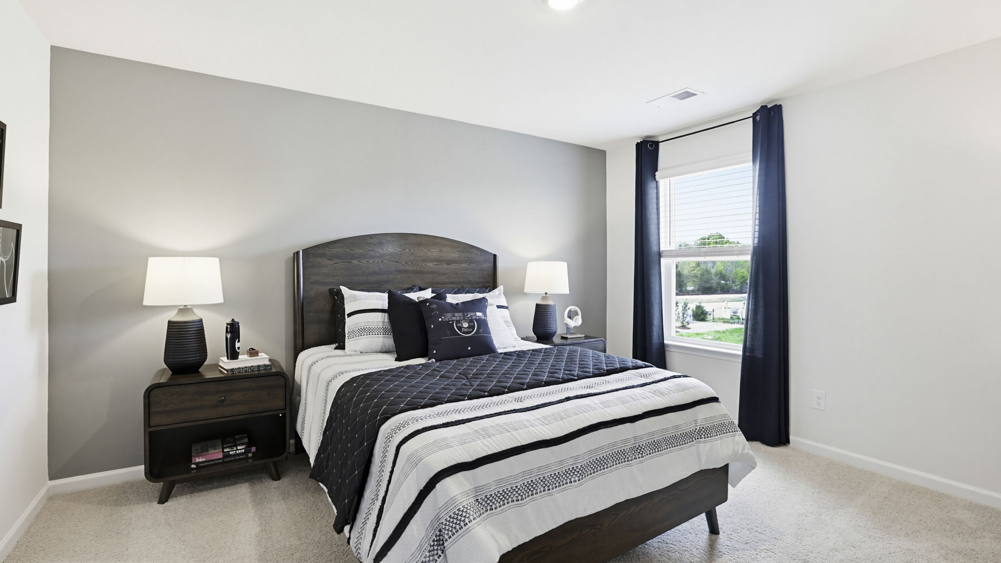 Bedroom with carpet and window.