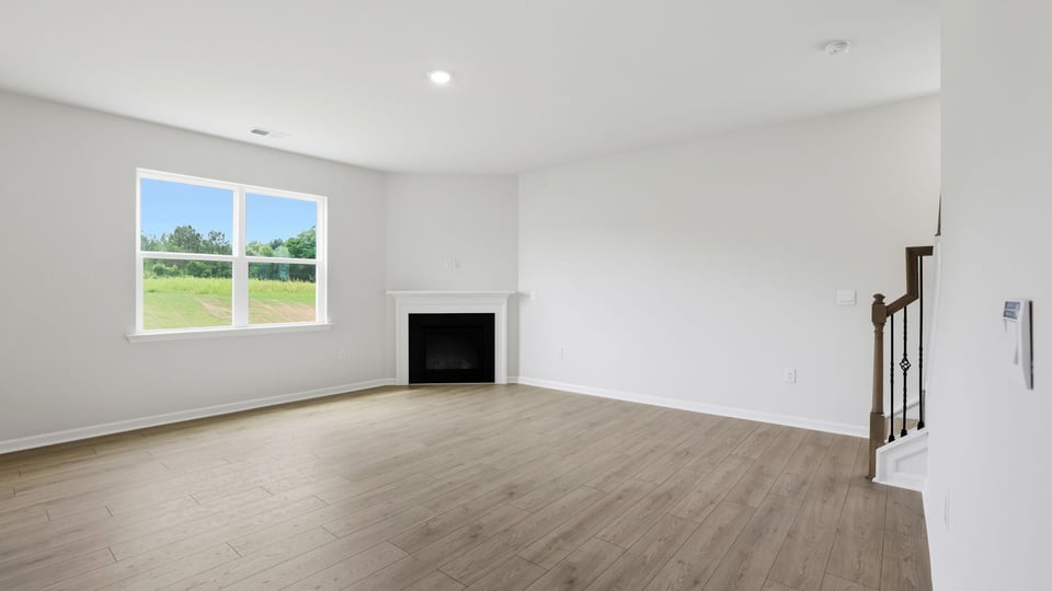 Living room with fireplace and windows.