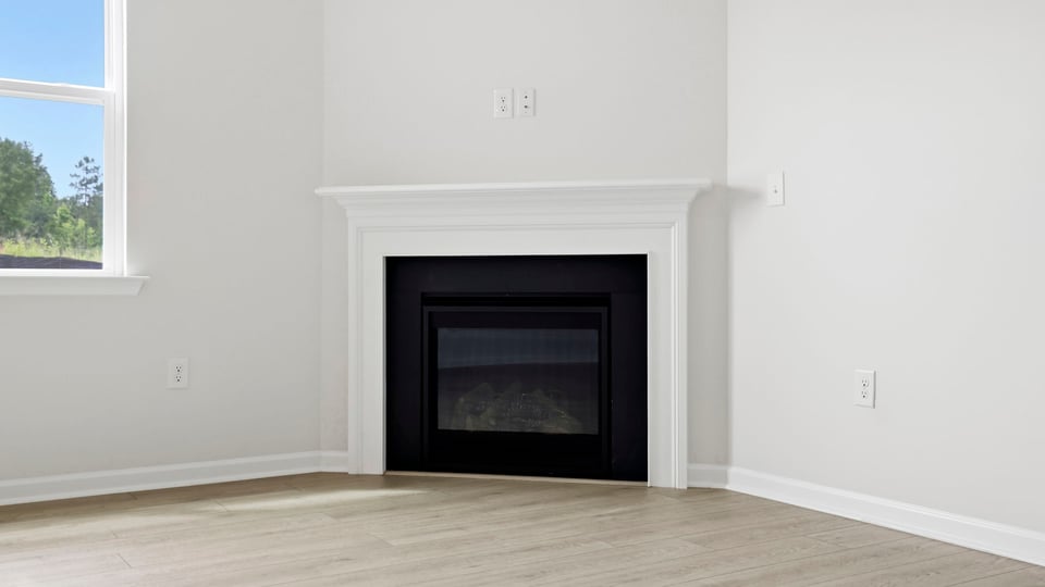 Living room with fireplace and windows.