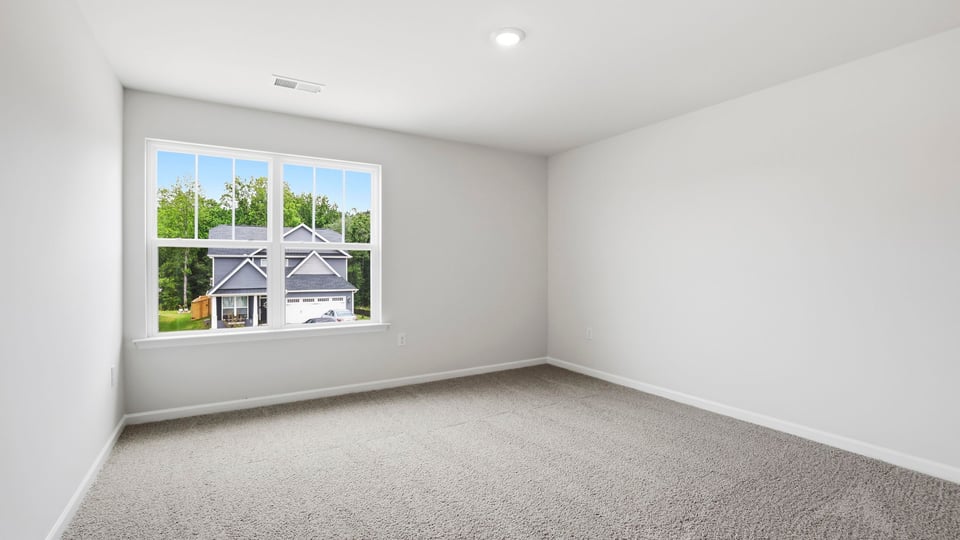 Bedroom with carpet and windows.